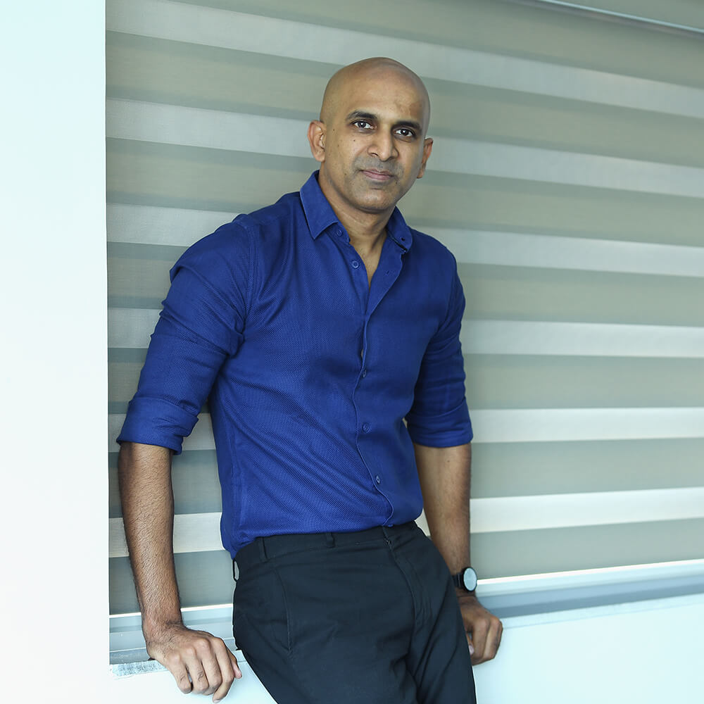 A guy smiling in v neck t shirt