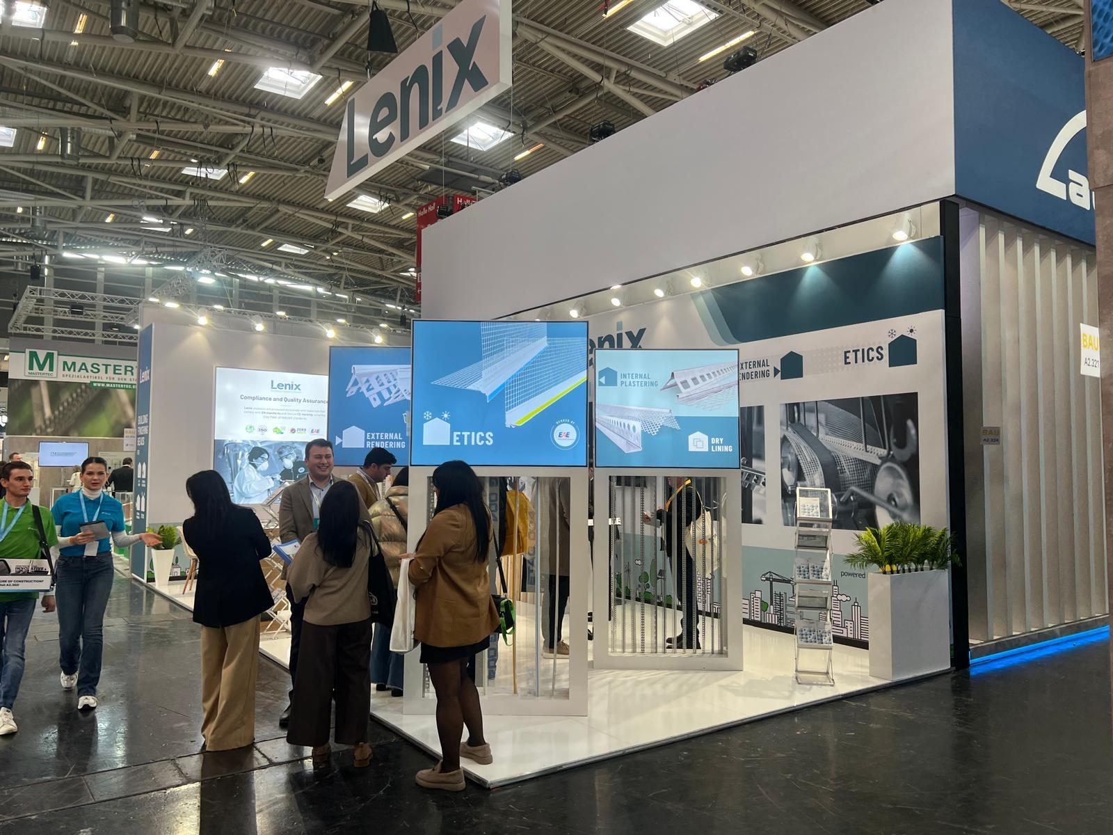 Lenix exhibition stand at BAU 2025 Munich, featuring a clean, modern design with bright white walls, blue corporate accents, and large product graphics.
