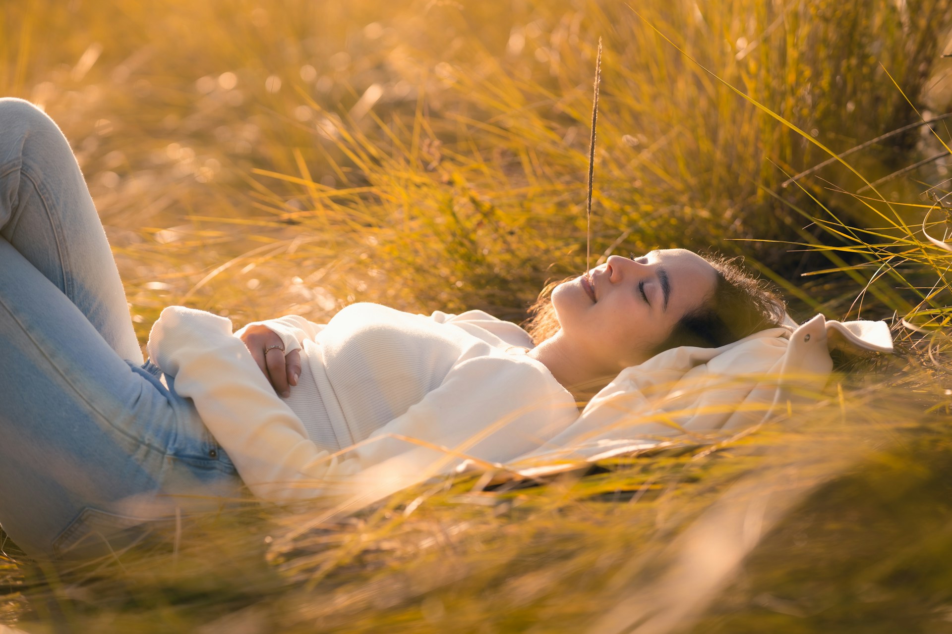 Woman lying on grass, enjoying a quiet moment in nature