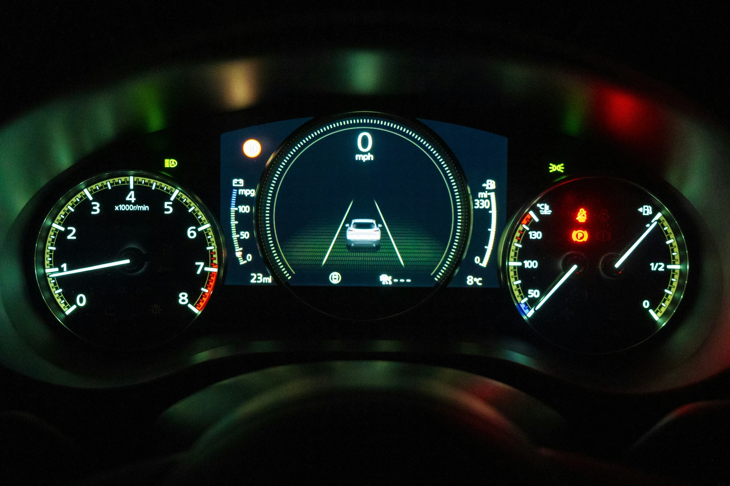 A car dashboard with a lane monitoring display  