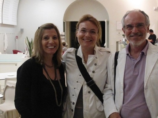 A photo of three persons in a room.