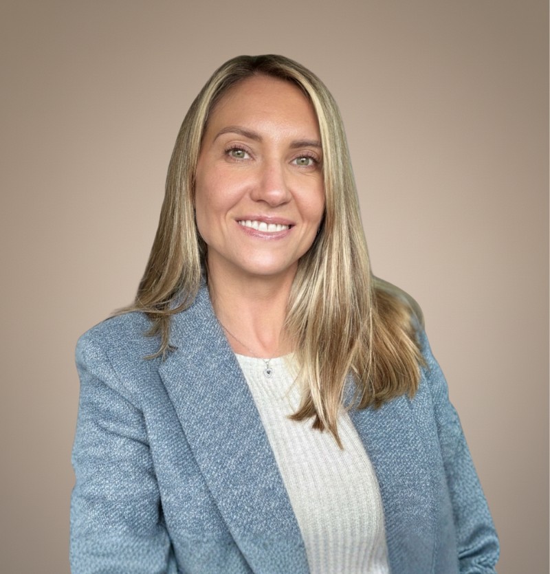 woman in brown coat using macbook air