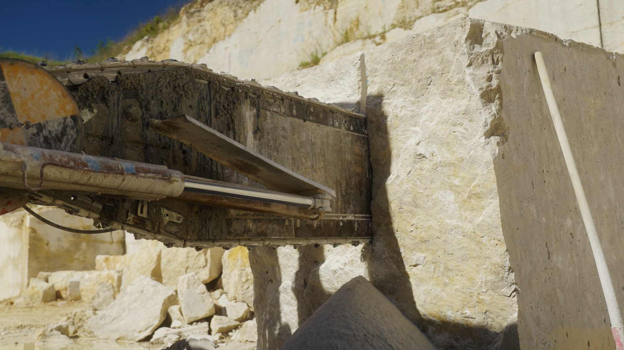 Machinery cutting stone in quarry, showcasing strategic filmproduction, storytelling, and communication for branding.