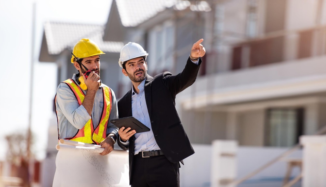 Two men speaking in a construction site