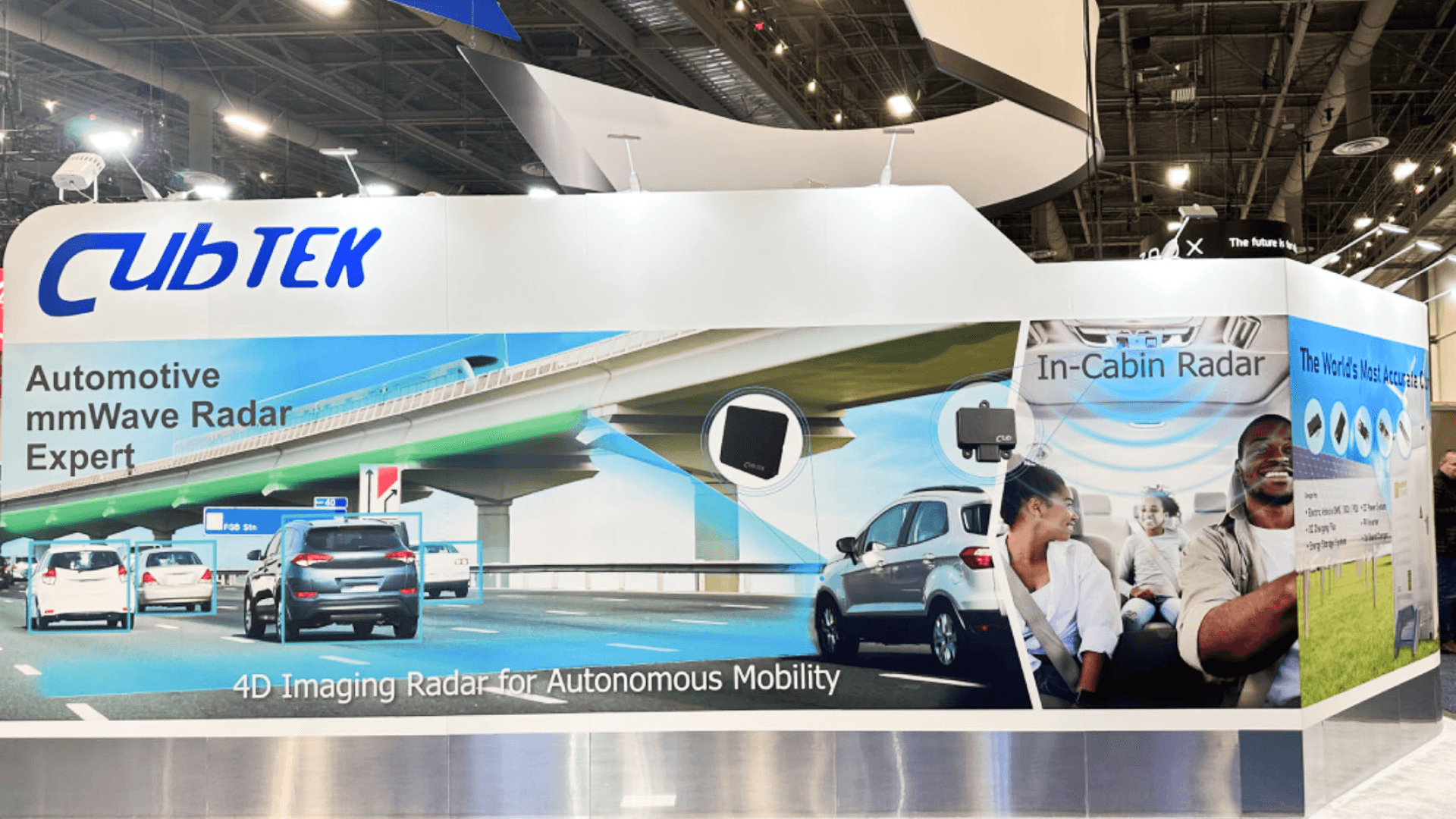Large curved back wall graphic illustrating "Automotive mmWave Radar Expert" capabilities with lifestyle imagery.