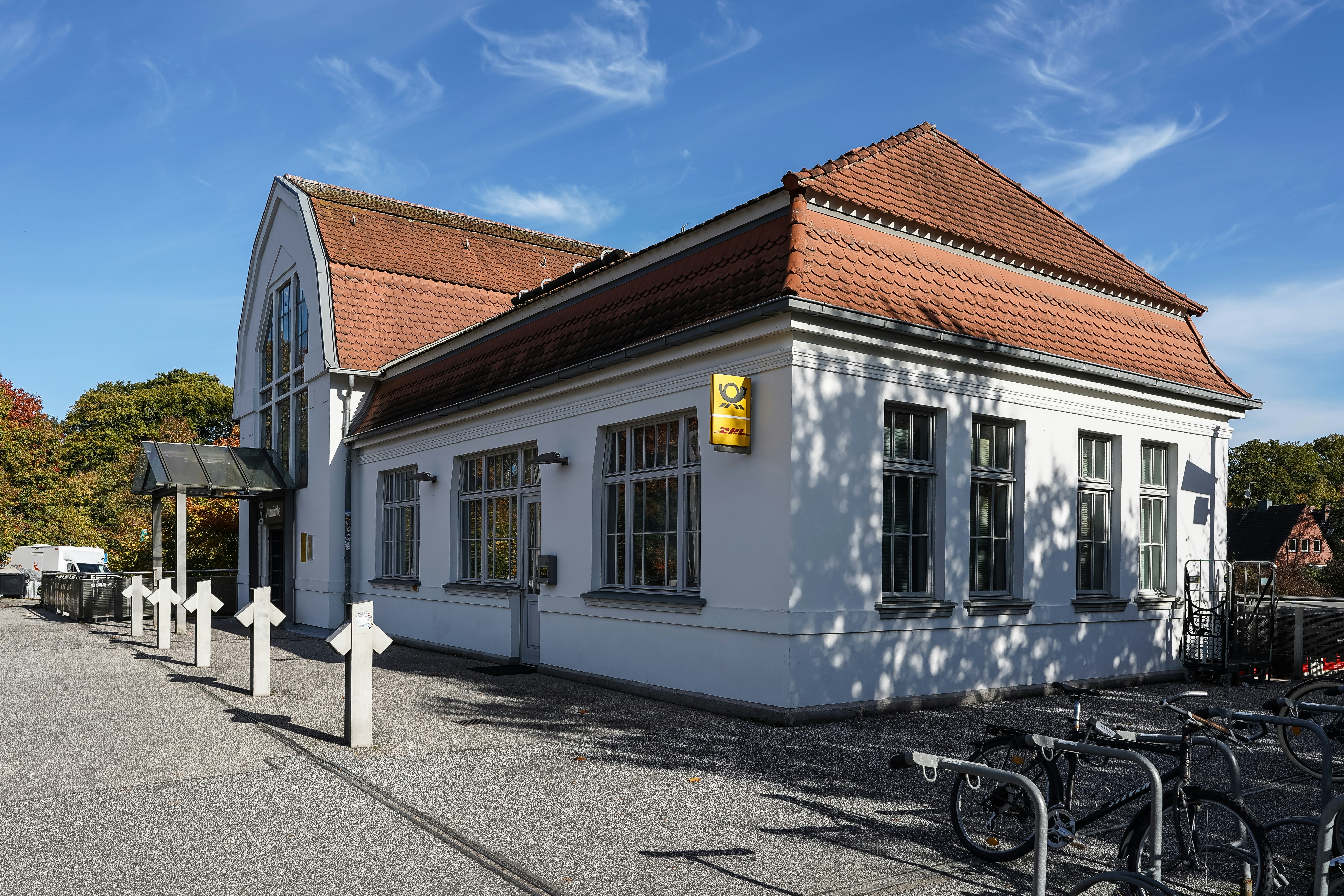 White building with red roof under blue sky