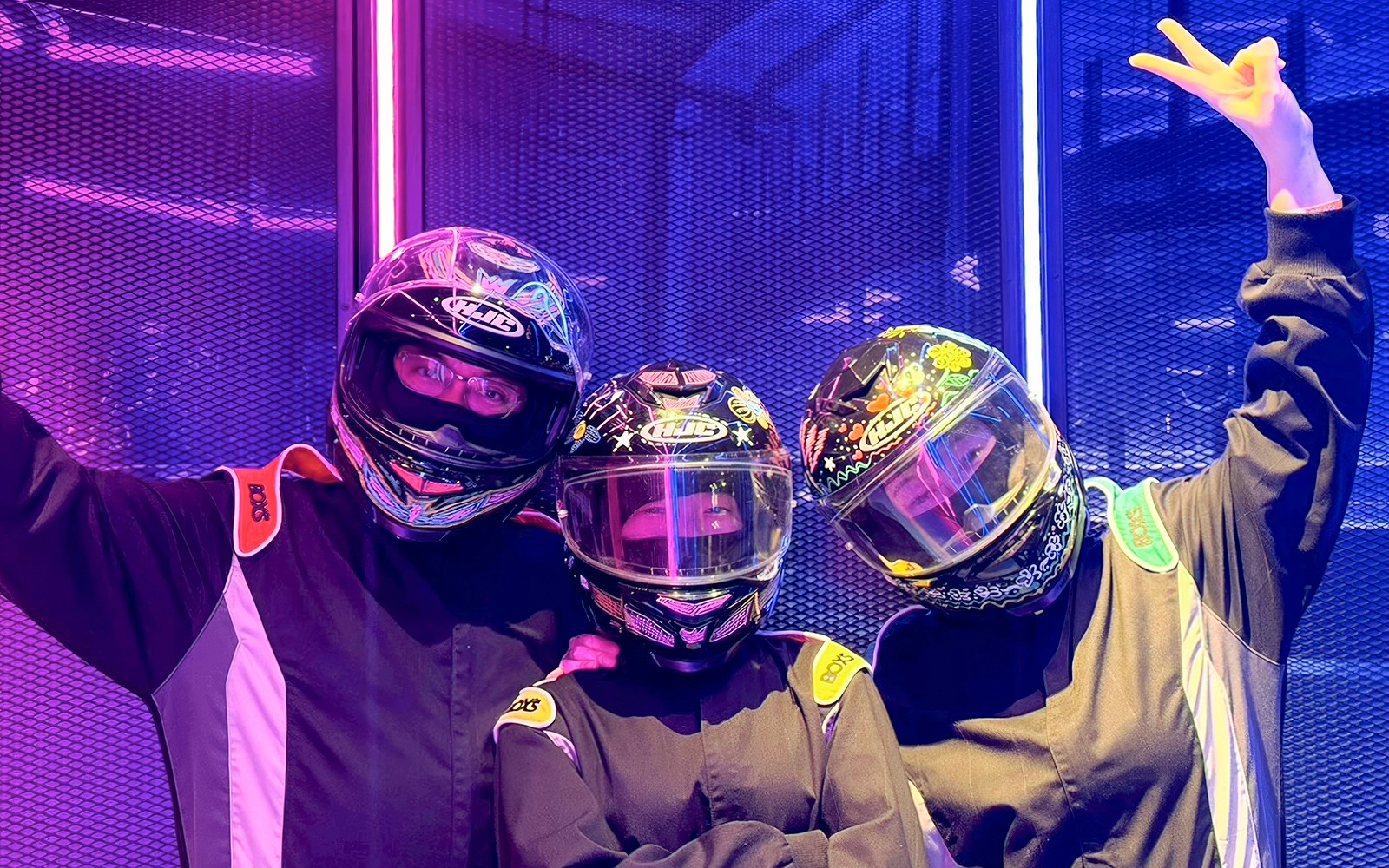 Three go-kart racers in full gear at Hyperdrive in Singapore