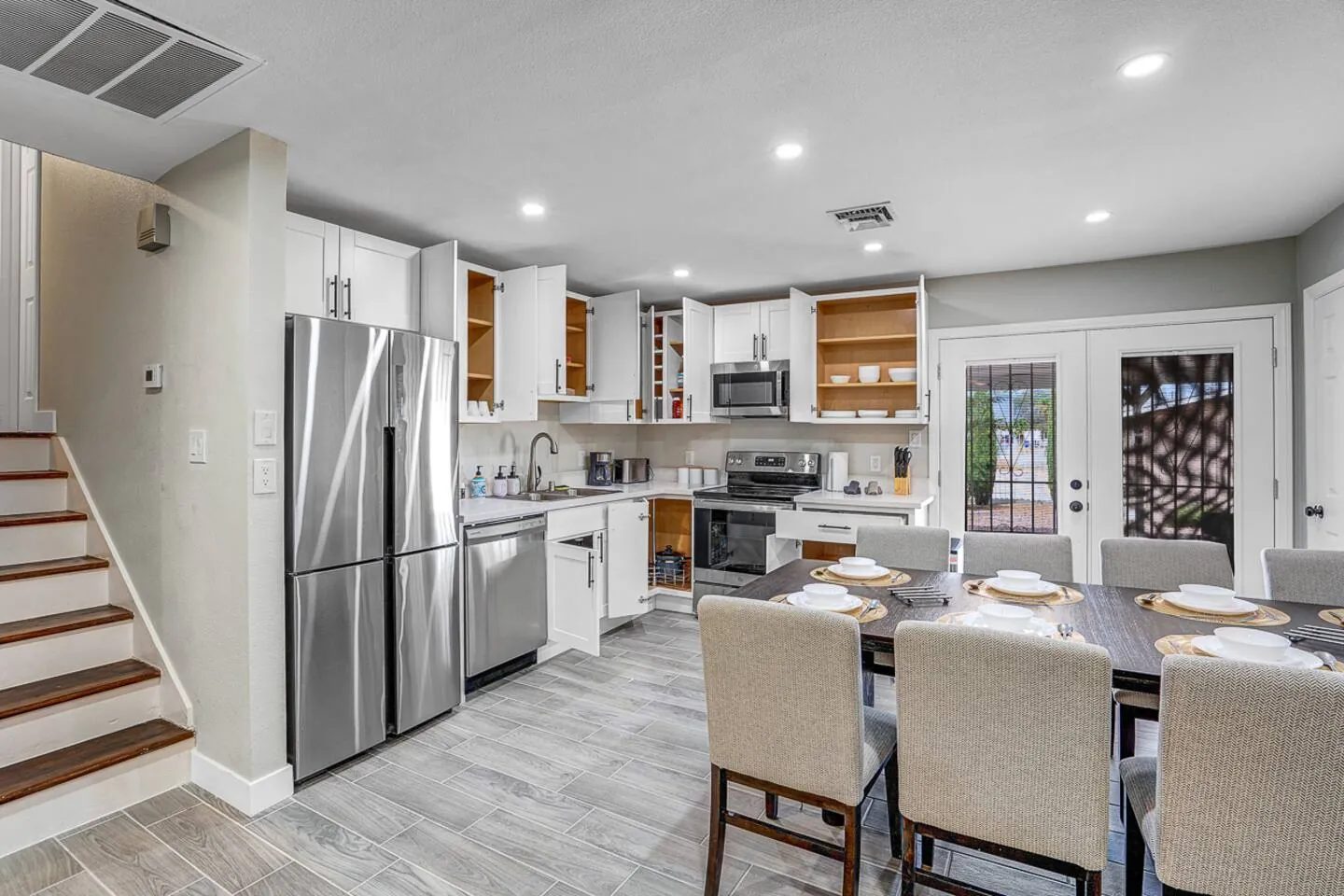 Living and dining room with the kitchen beyond, Family Reunion Home in North Las Vegas