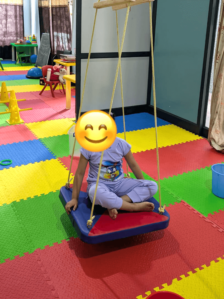 Child participating in swing therapy at Blissful Care Center