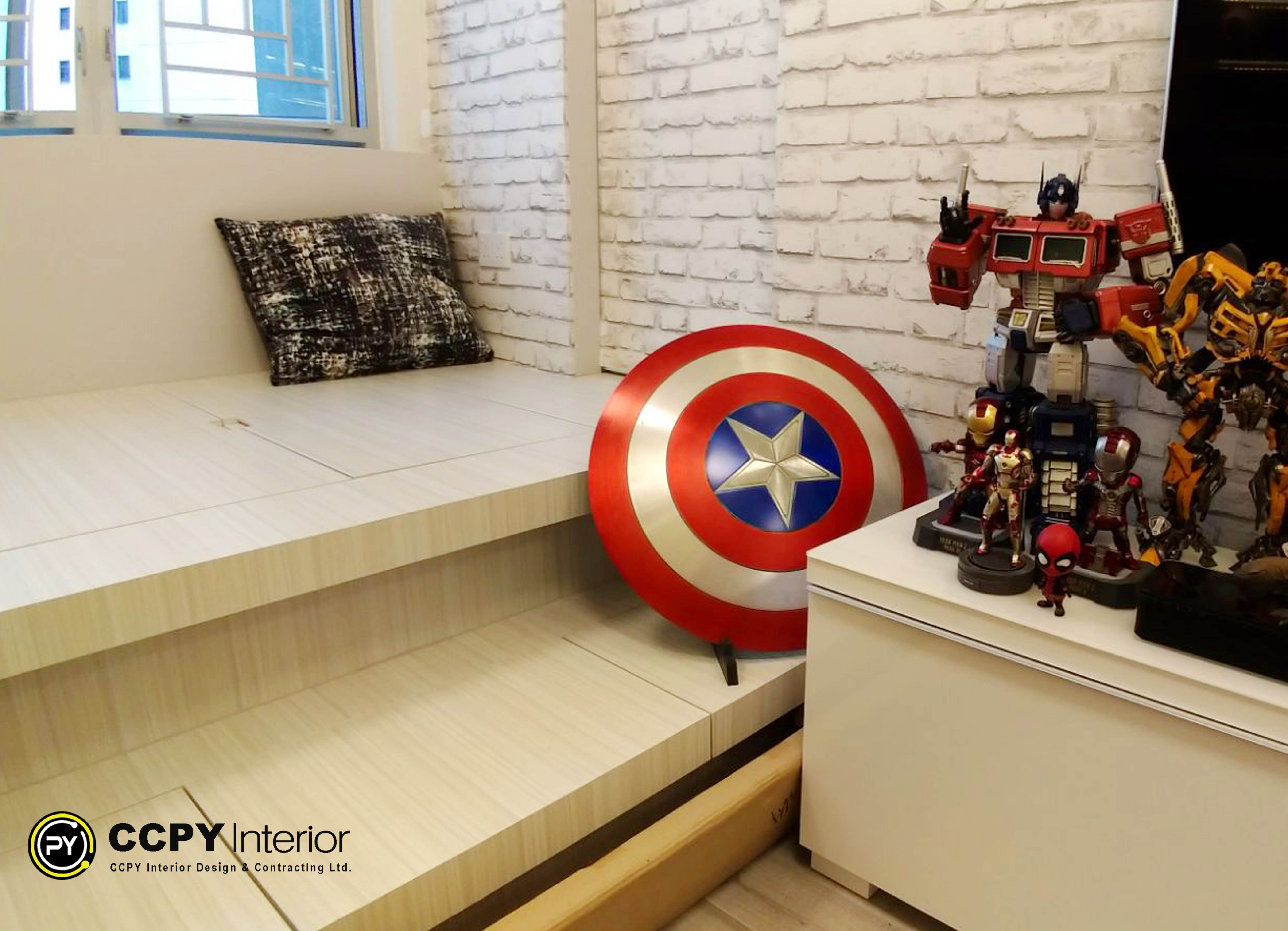The selected region shows an elevated platform bed or seating area decorated with pop culture memorabilia, including Captain America's shield and Transformers action figures.