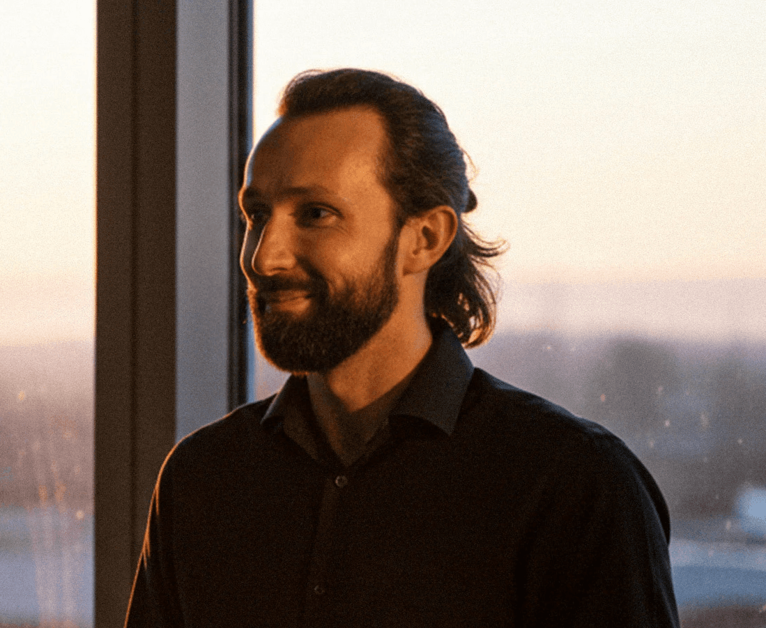 A young woman poses for a black and white photo.