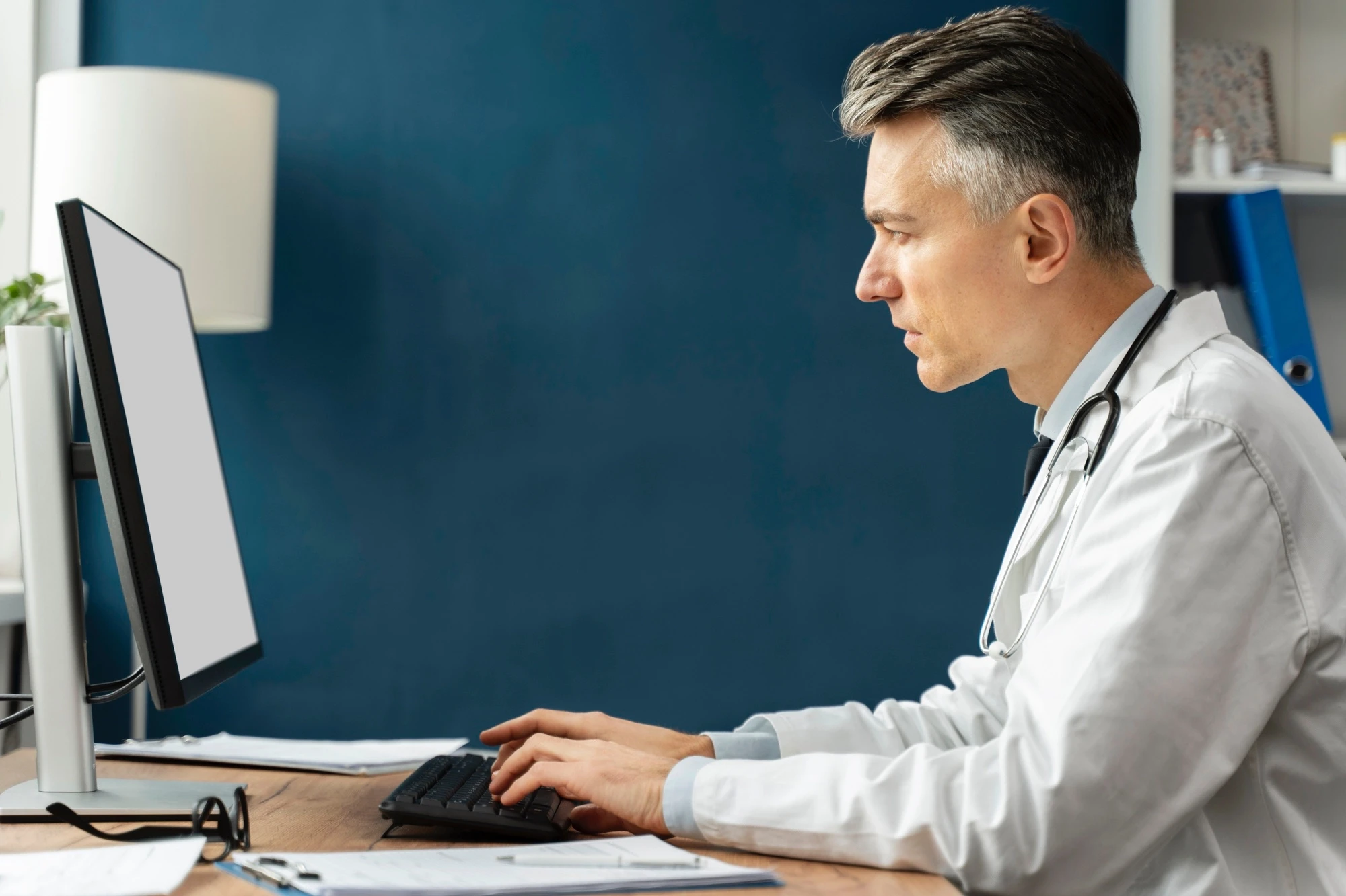 Doctor looking intently at computer monitor