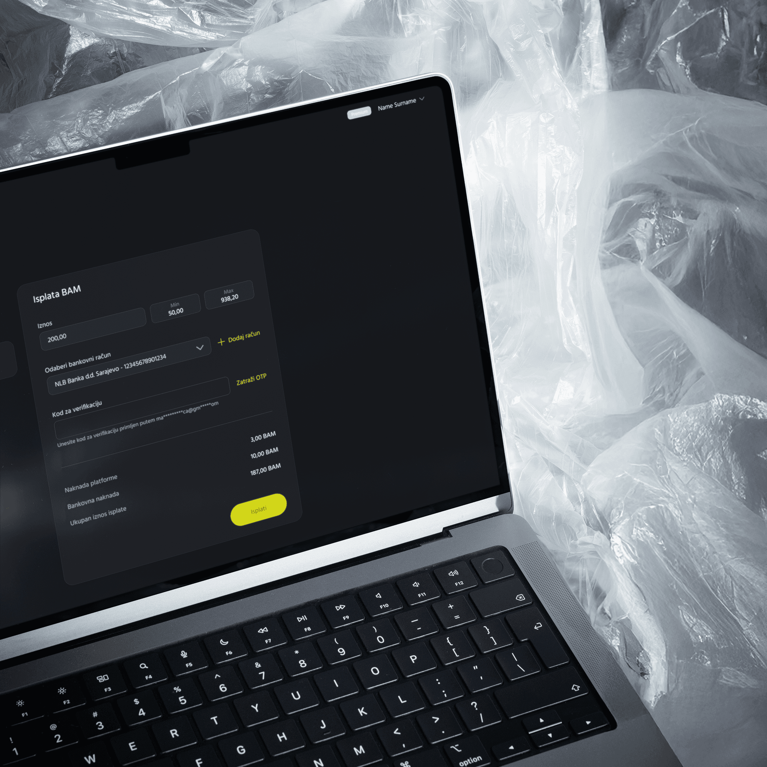 A laptop placed on the crumpled nylon sheets, with its screen showcasing the payout feature of ACX's web app, designed by ofc. Studio.