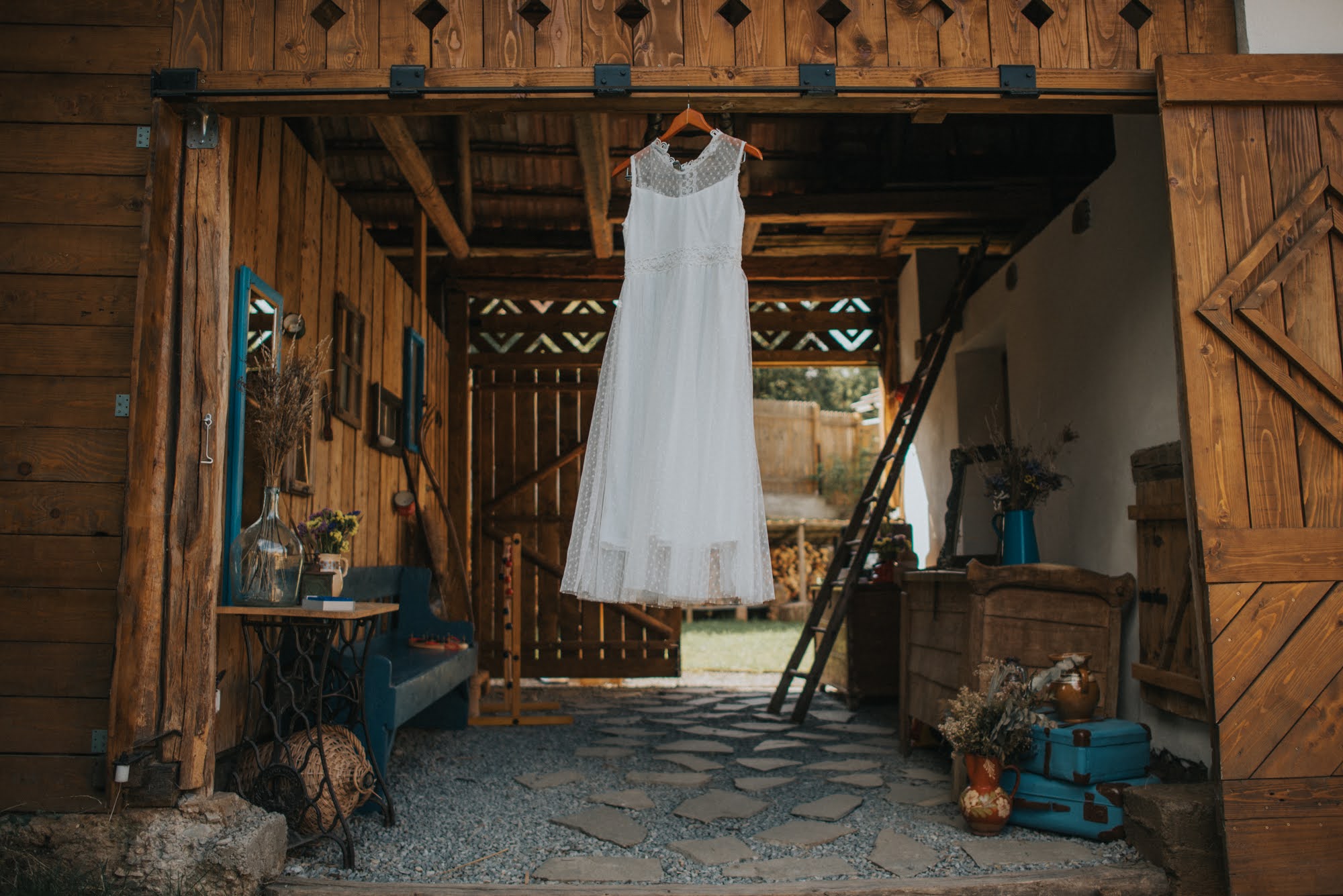A woman in jeans jacket, holding a camera.