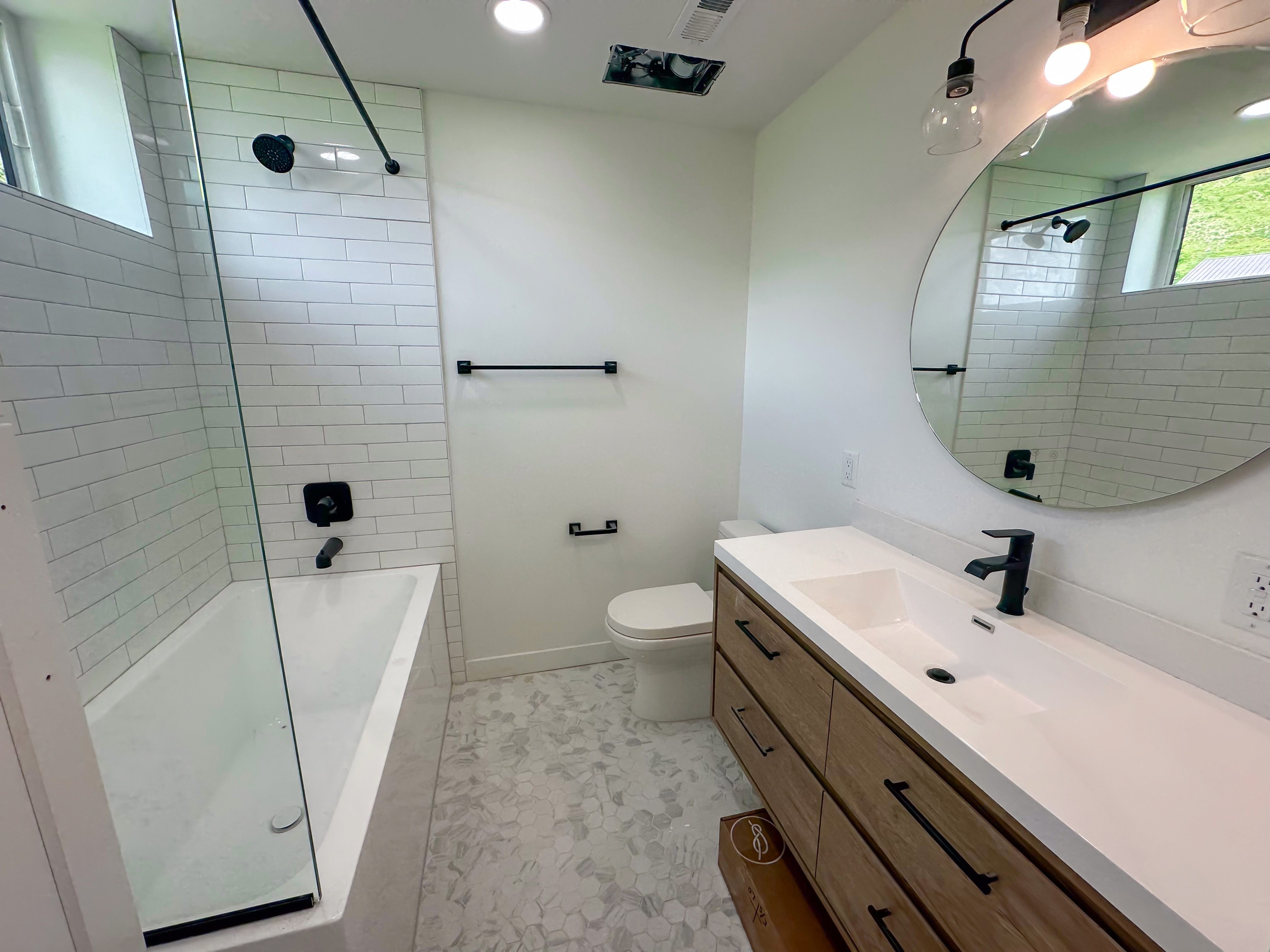 Modular home bathroom with a glass shower.