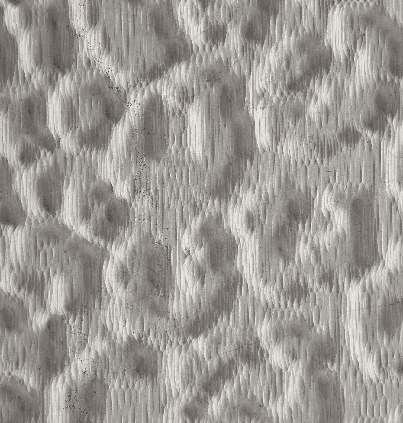 Carved marble surface study inspired by the irregular spotted rhythm of leopard skin, translated into an abstract tactile relief.