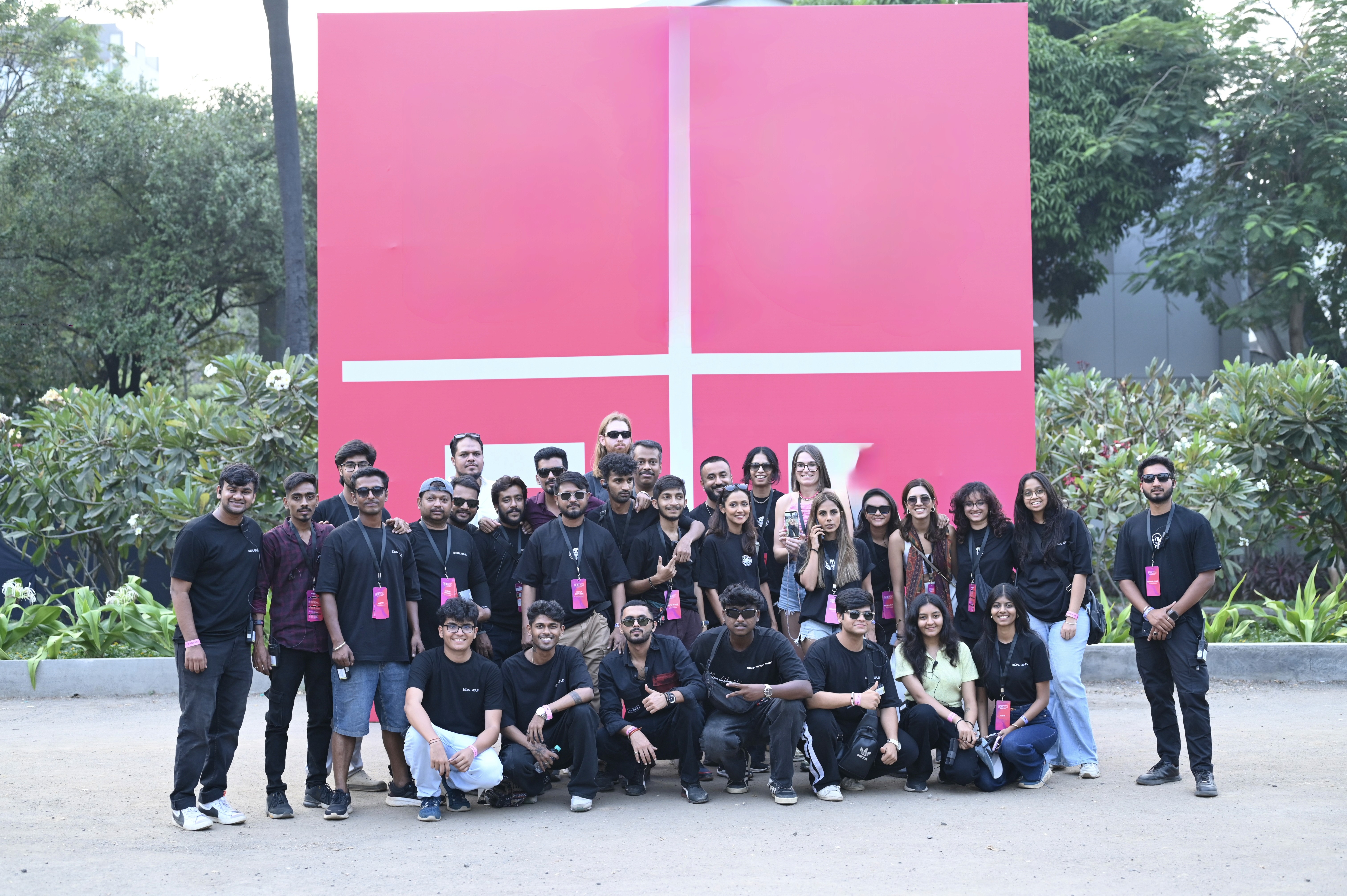 A black and white photo of a man standing in front of a door