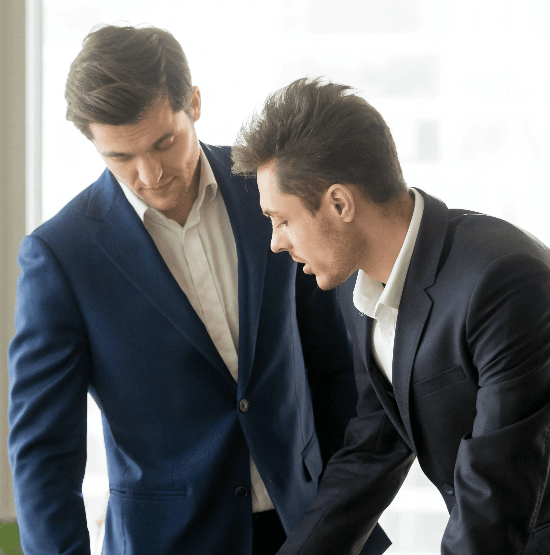 A man wearing a blue sweater looks off to the side with a contemplative expression.