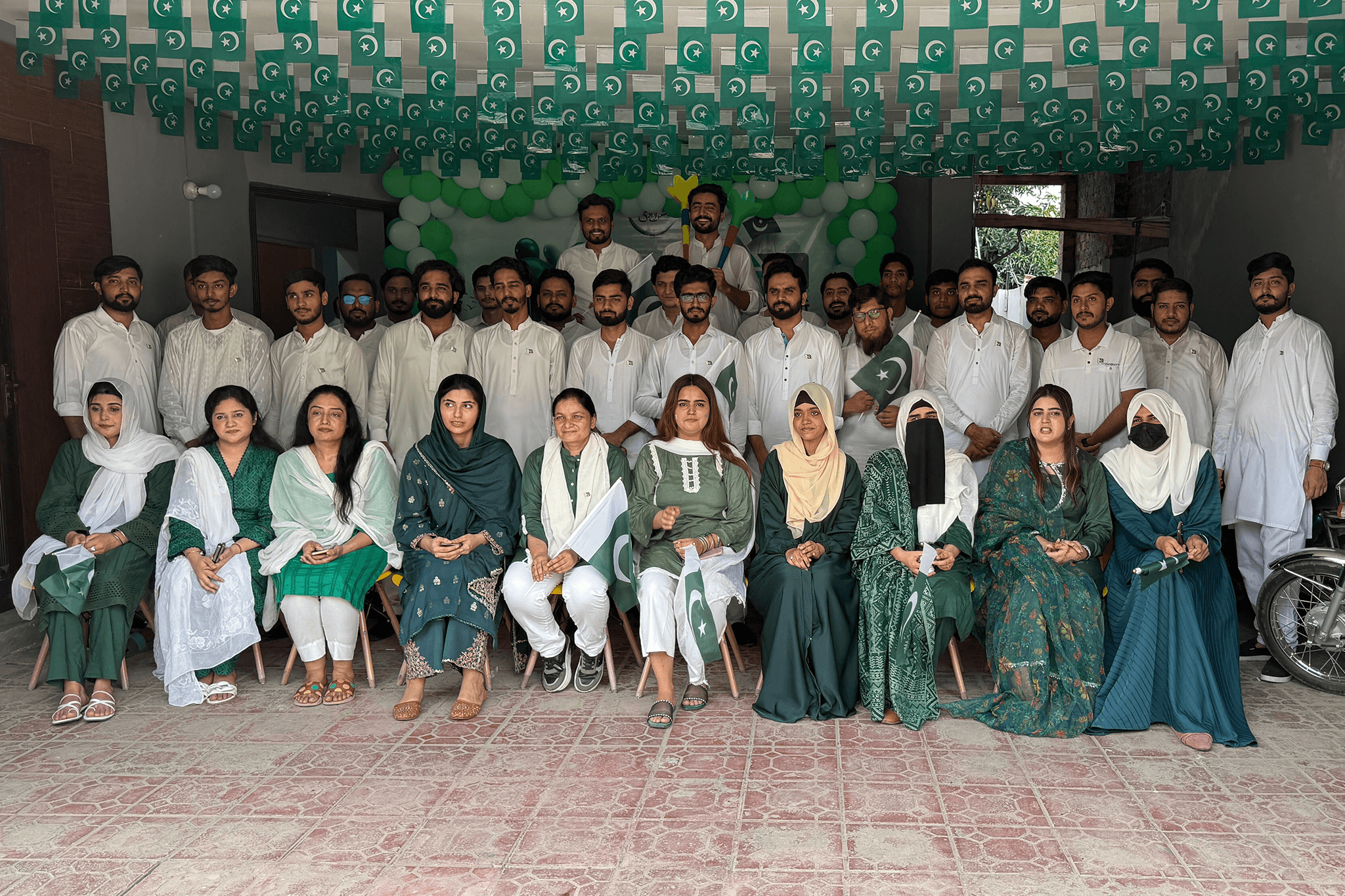 three men sitting while using laptops and watching man beside whiteboard