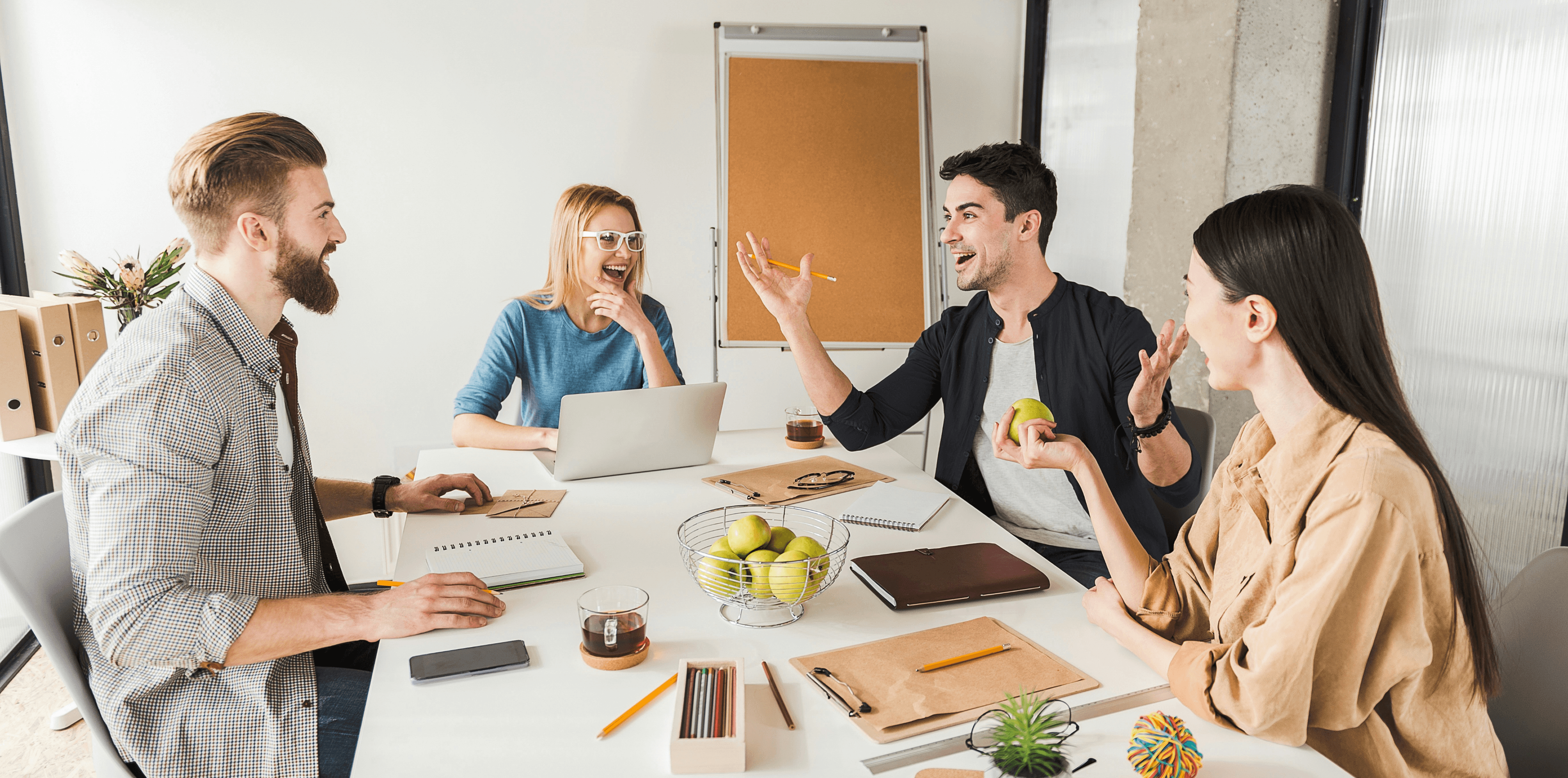 Diverse team celebrating together in a modern workspace, representing collaboration and positive work culture