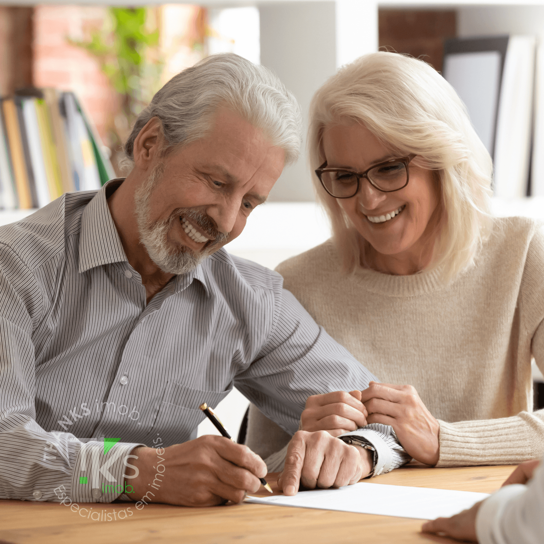 A white building with a balcony and windows, representing an apartment complex, set against a serene blue sky.