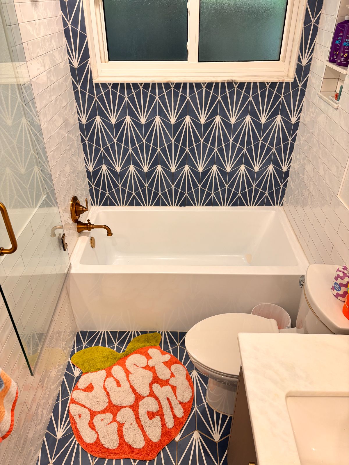 Deco-tile bath with brushed gold fittings