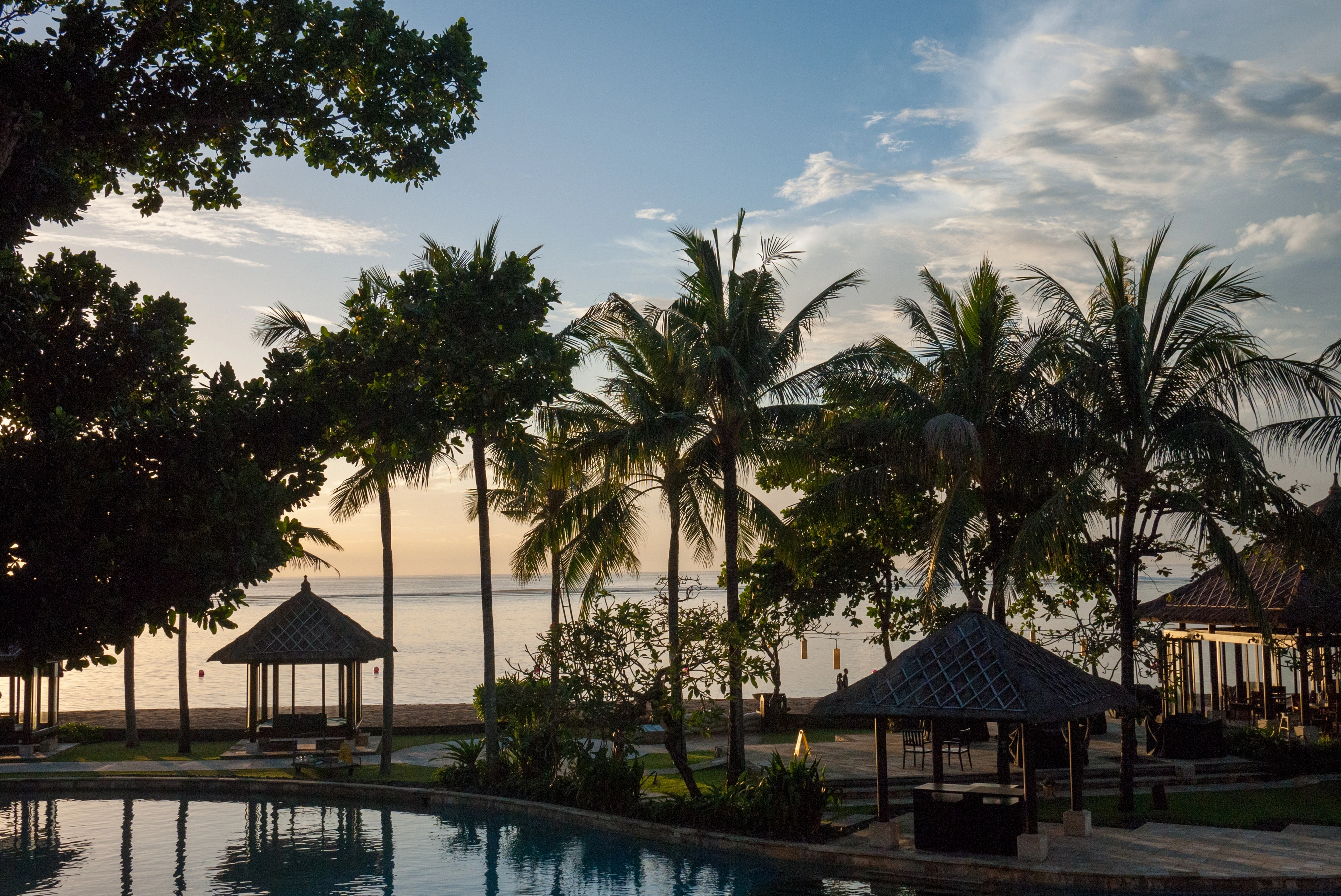 Naraya Lagoon pool bordered by thatched pavilions and tropical palms