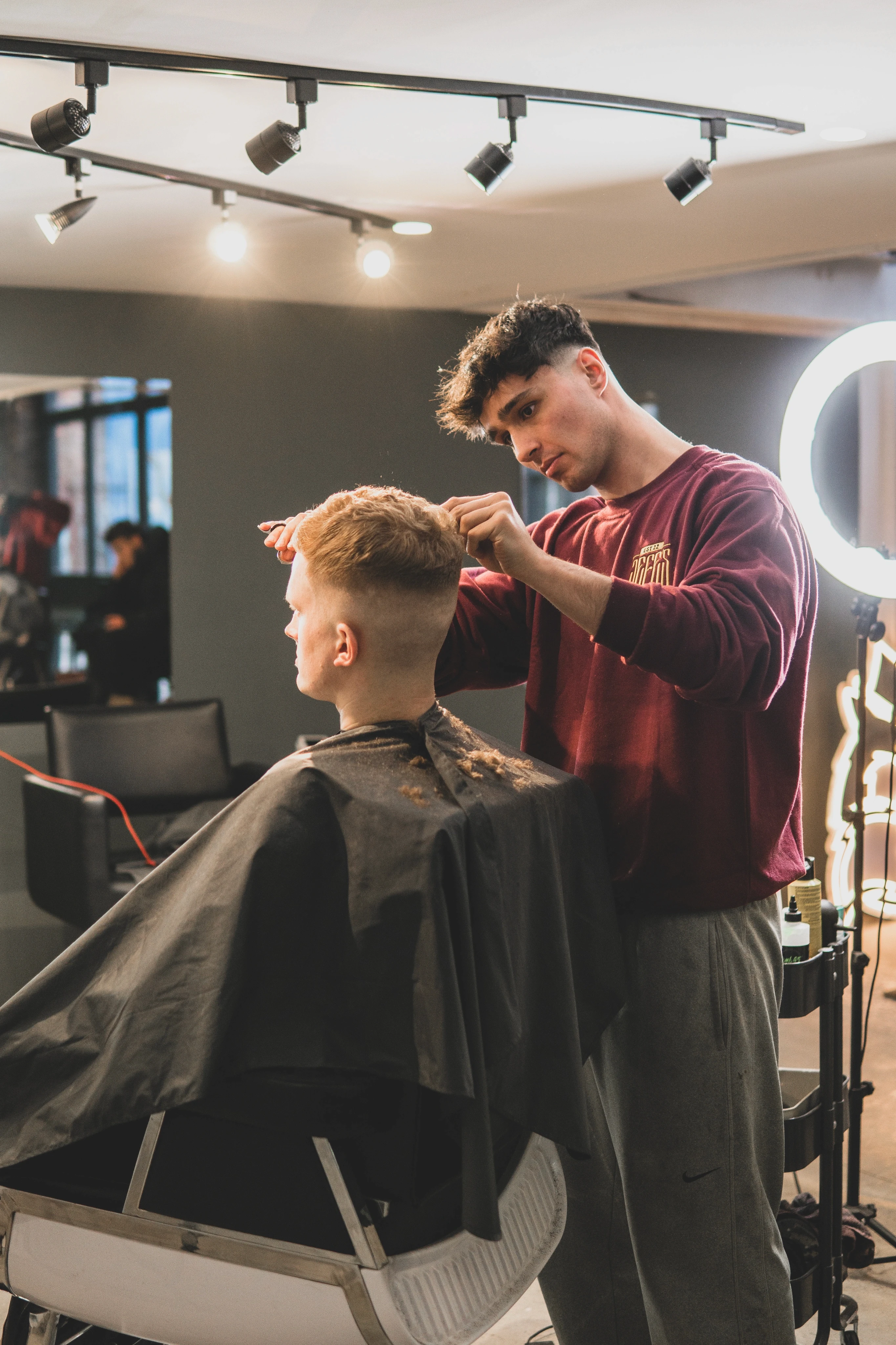man cutting hair of man