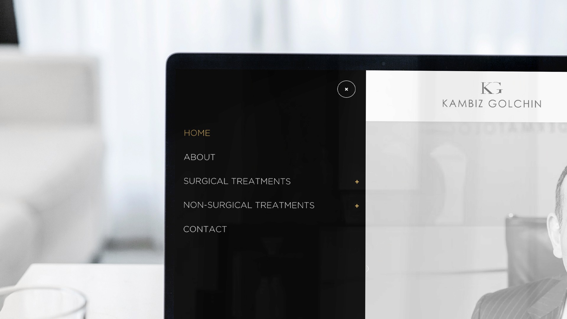 Website homepage of Kambiz Golchin with navigation menu, featuring sections for treatments and contact.