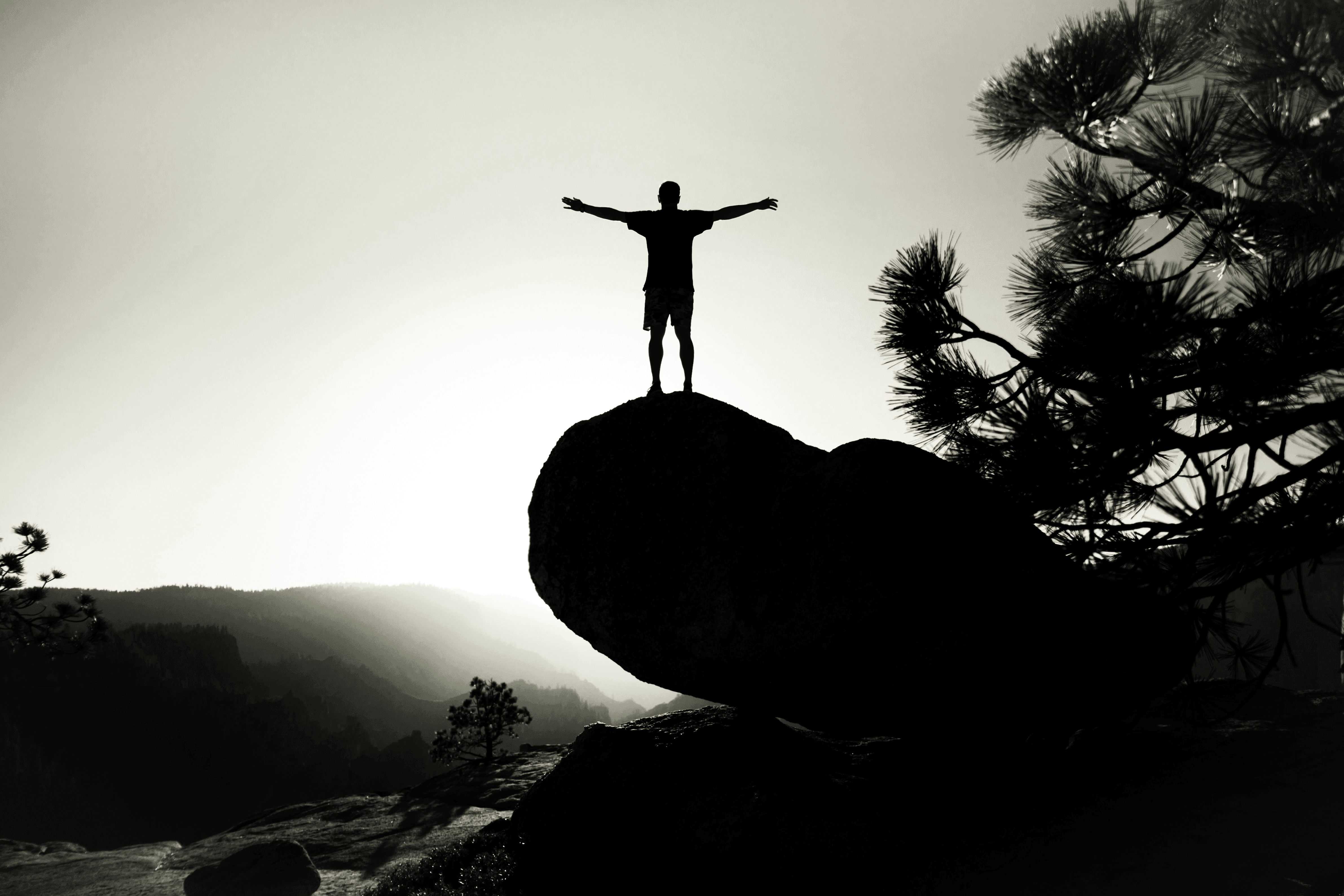 silhouette of person on rock
