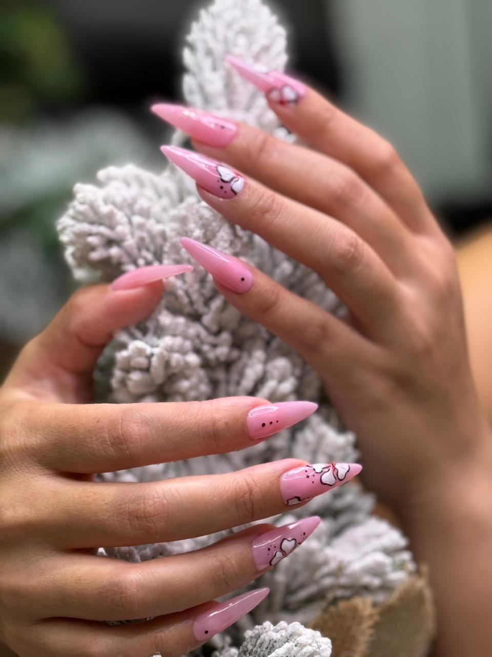 a woman is doing a manicure on a child's hand