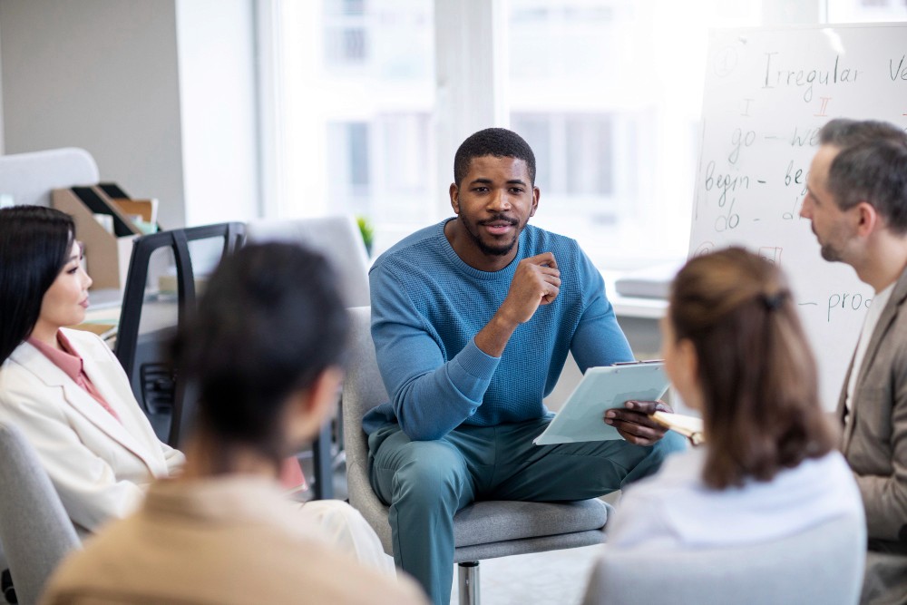 Young graduate presenting in classroom