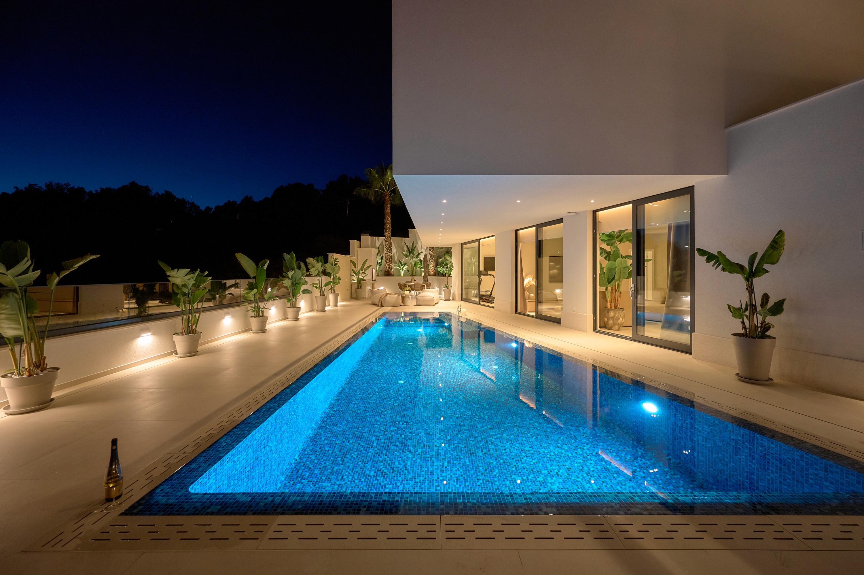 Black sports car in front of a modern, futuristic curved building.
