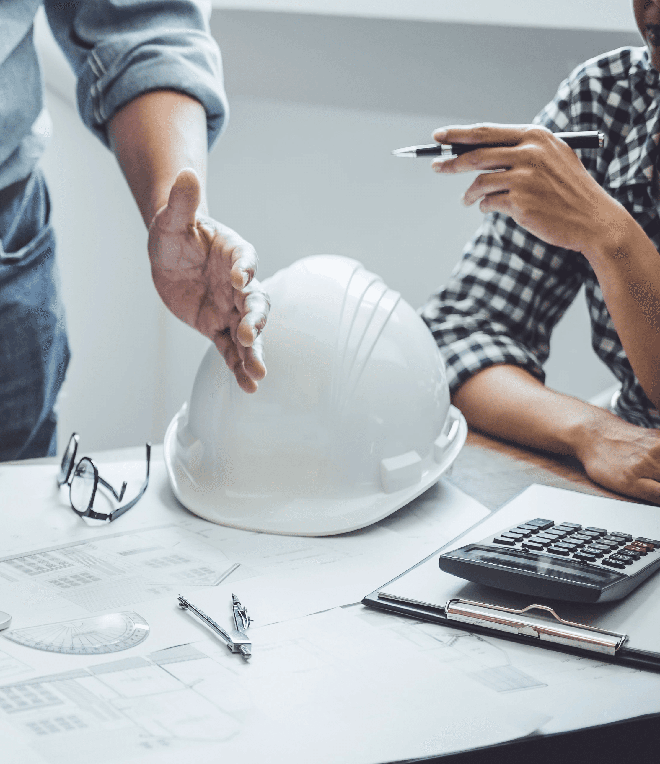 Construction worker wearing a hard hat and vest at site.