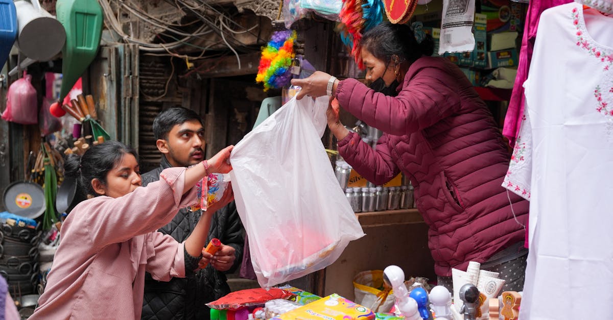 Vibrant street market scene with buyers purchasing goods from a vendor in an outdoor setting.