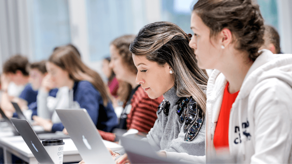 group of women in red and white dress standing on brown wooden bar during daytime