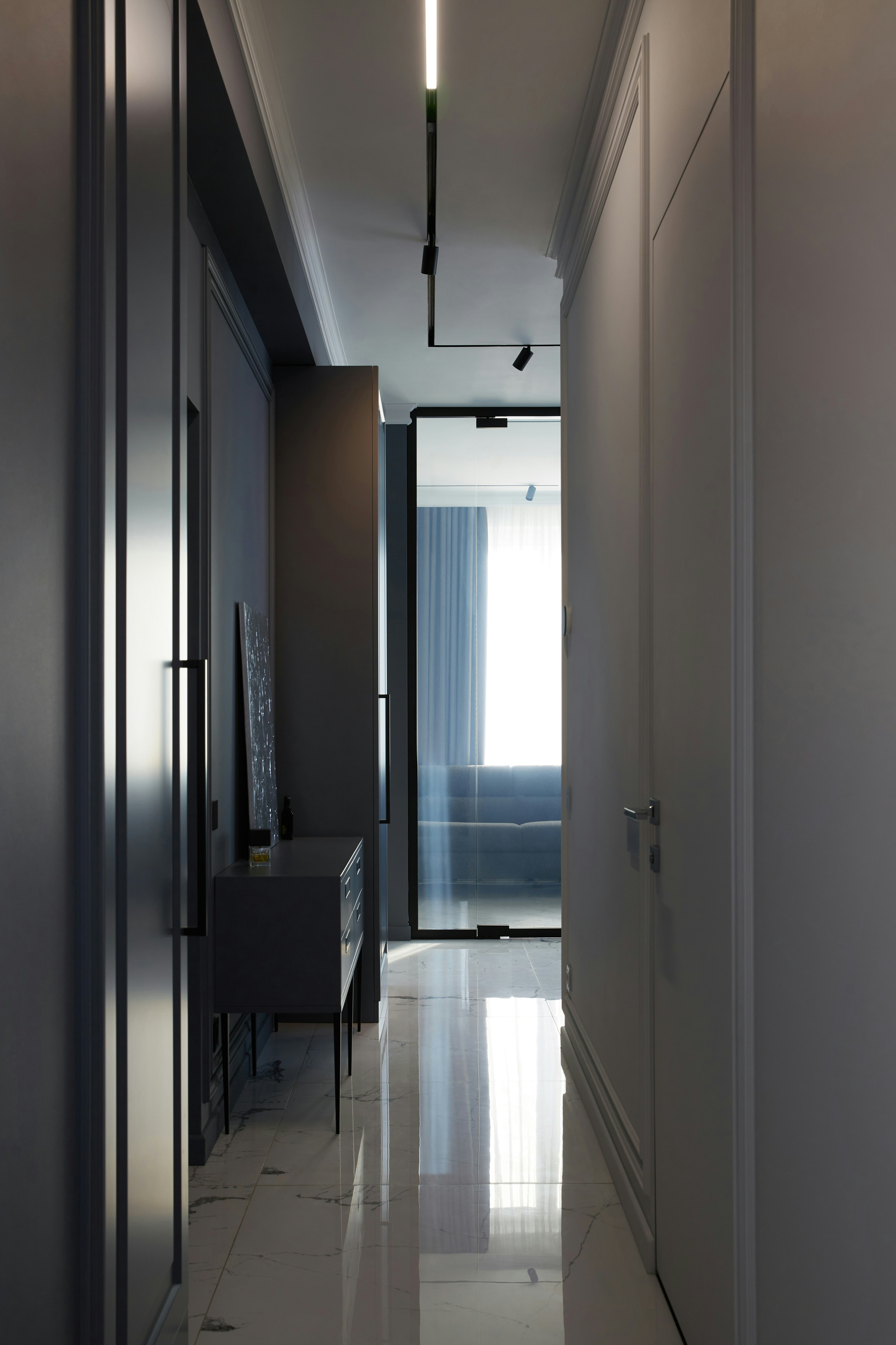 Modern hallway with mirrored doors and sleek furniture