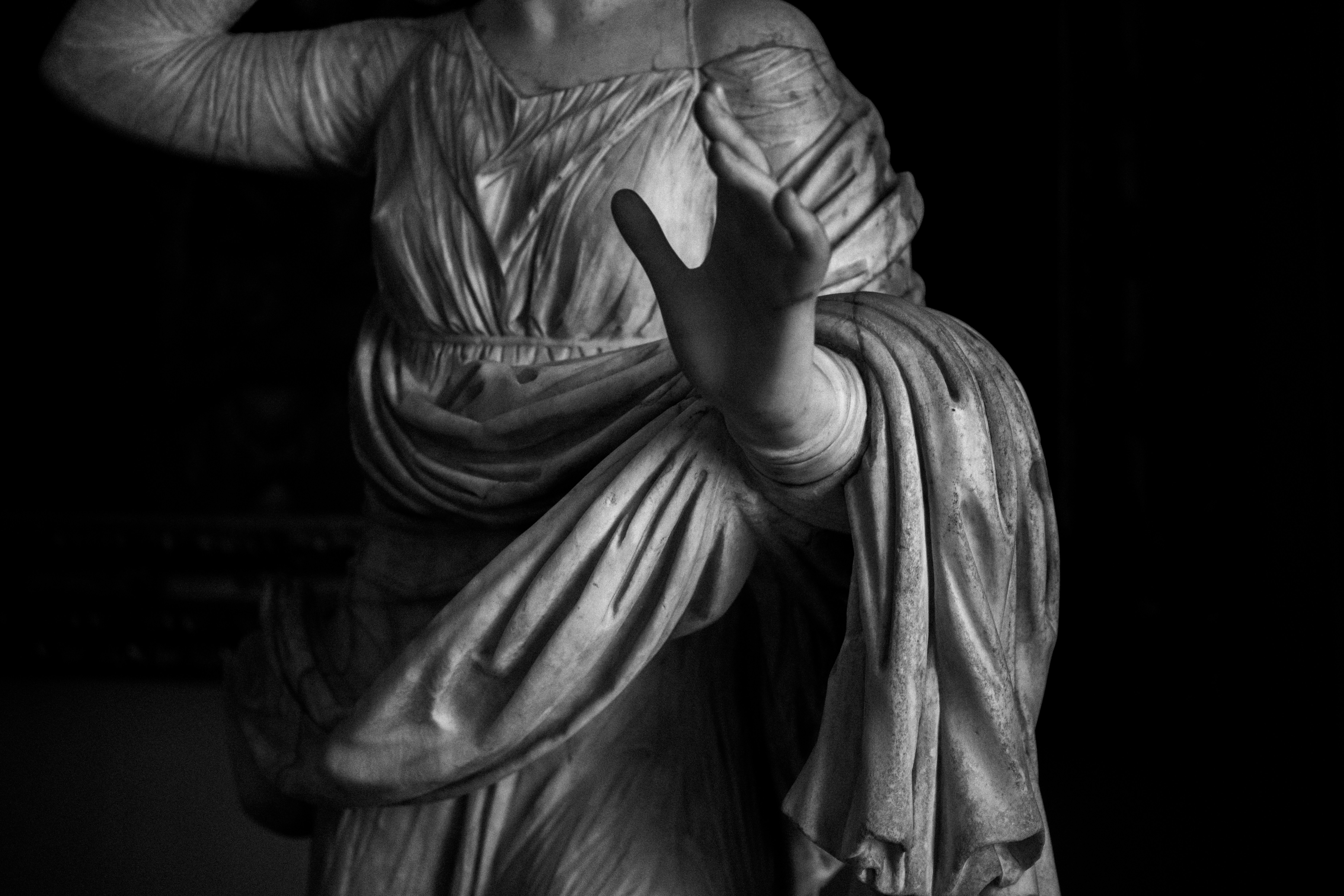 Classical marble statue of woman with dramatic high-contrast lighting