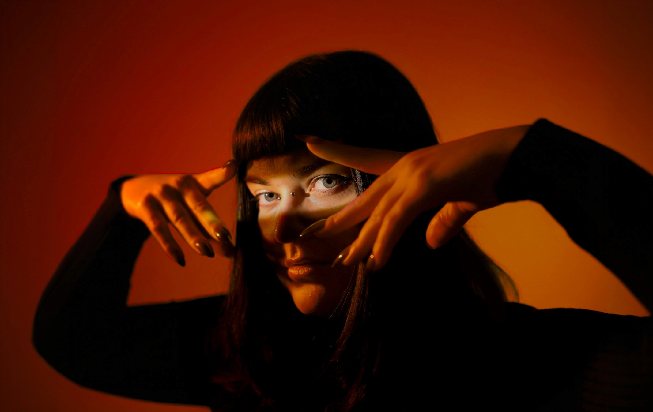 Women in front of an orange background