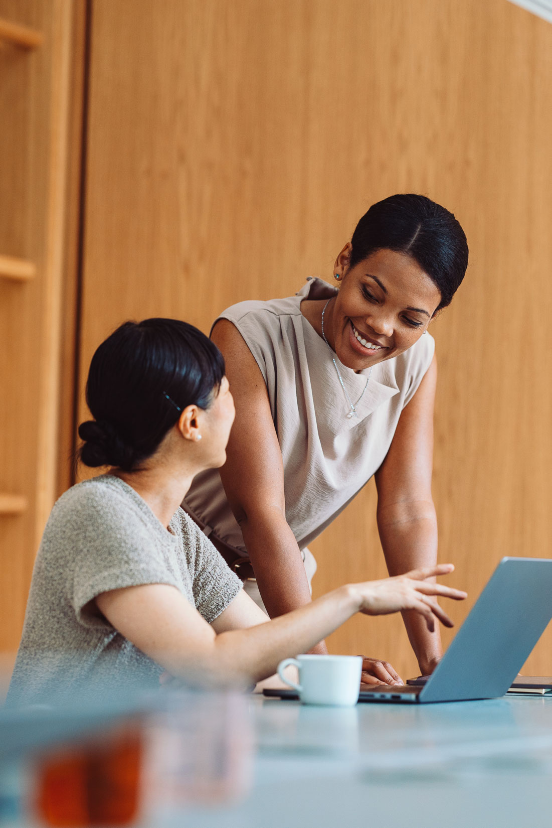 EB-1 visa lawyer consulting with colleague at laptop