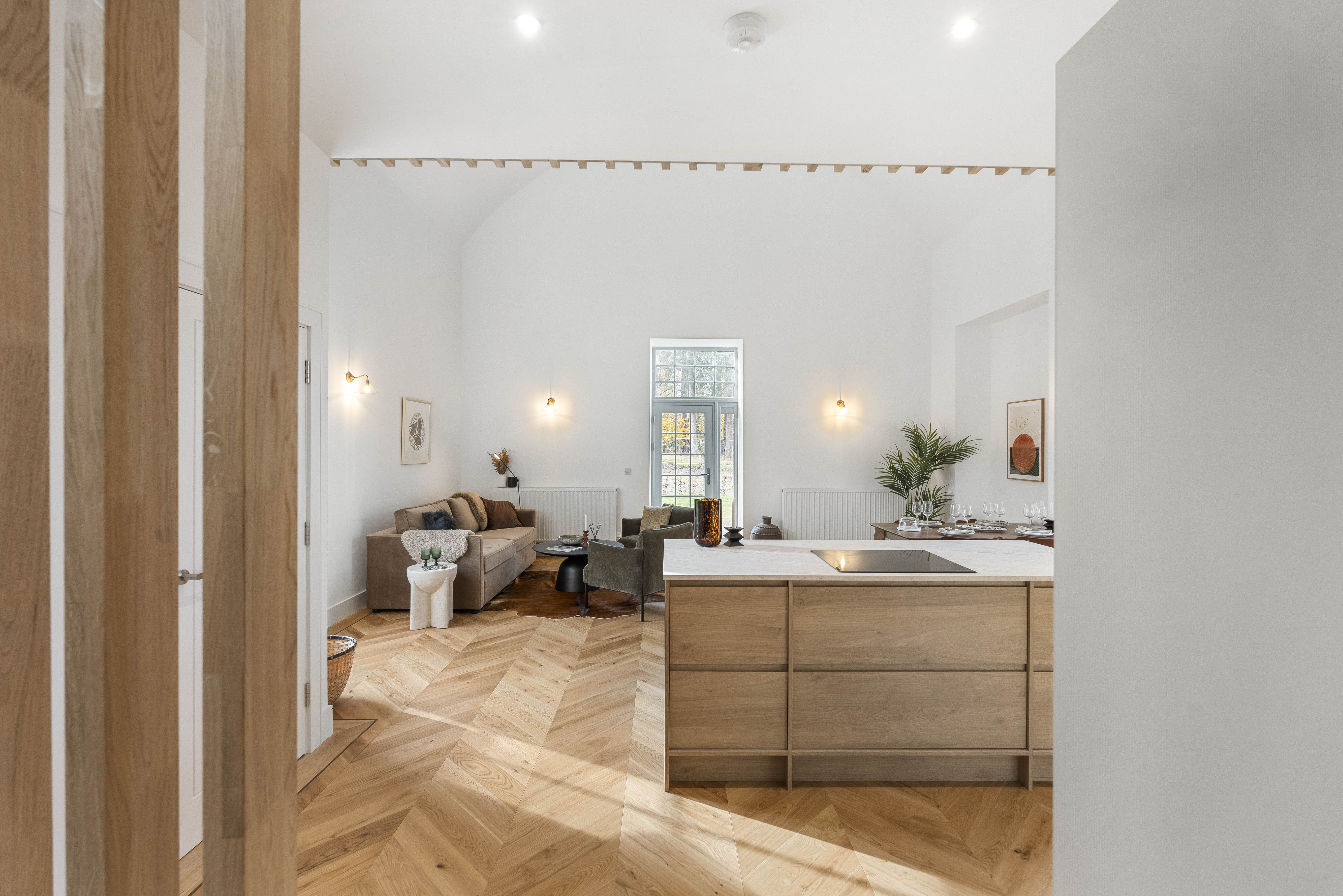 View of a bedroom entryway with an open door, showing a glimpse of the interior including the bed and surrounding decor.