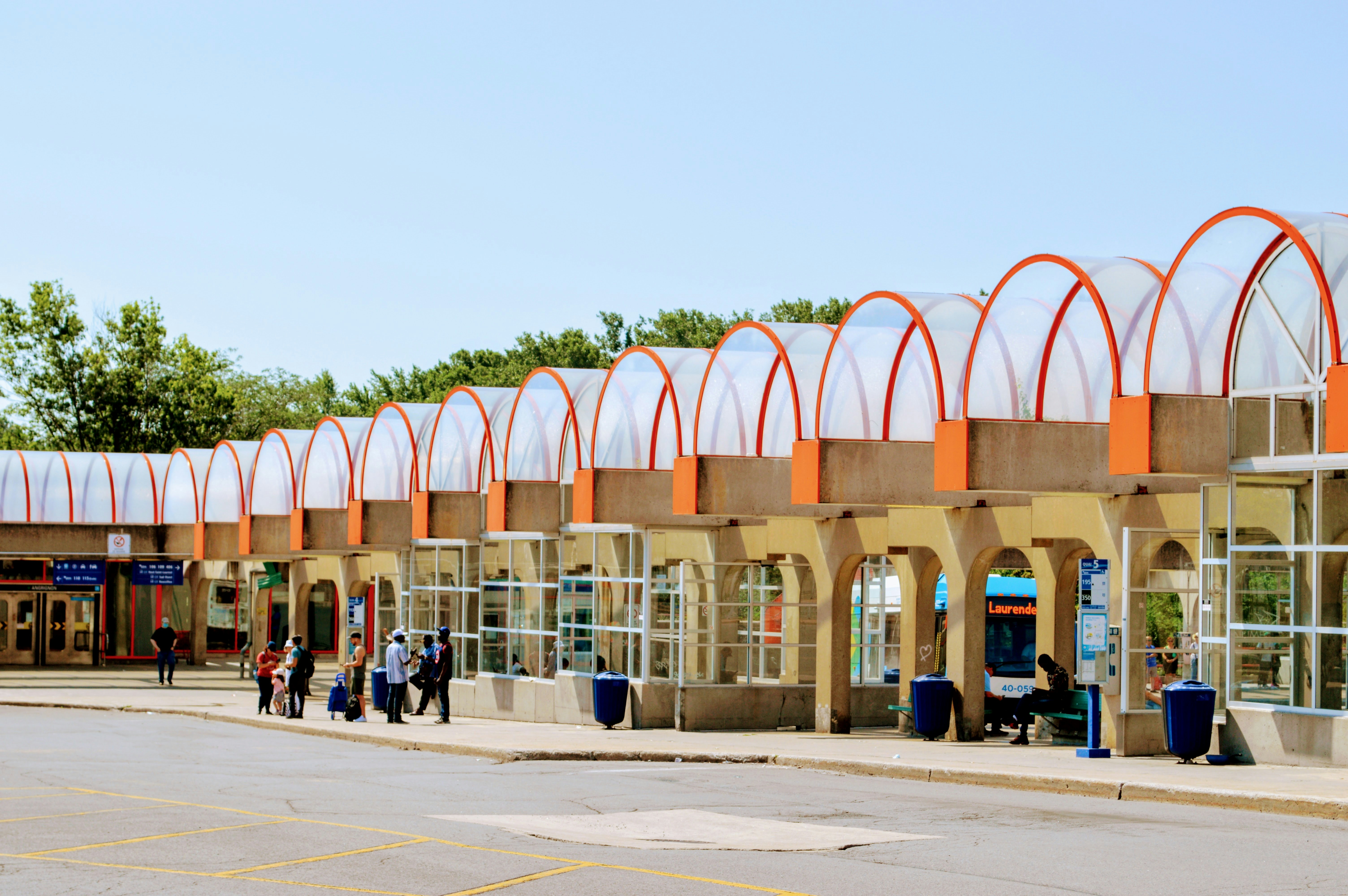 a group of people standing outside of a train station