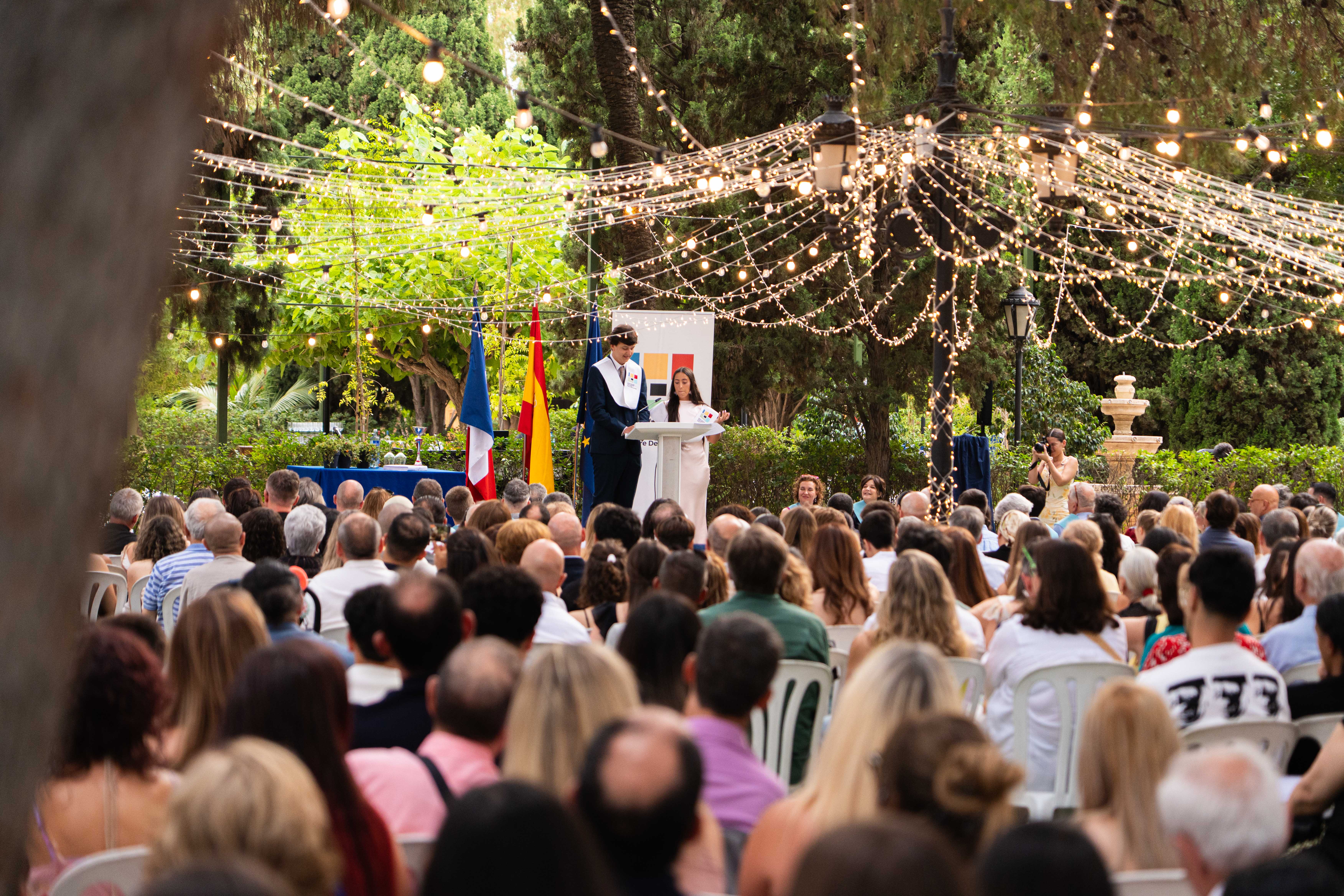 Two men wearing yellow and black face masks, standing side by side, with neutral expressions on their faces.