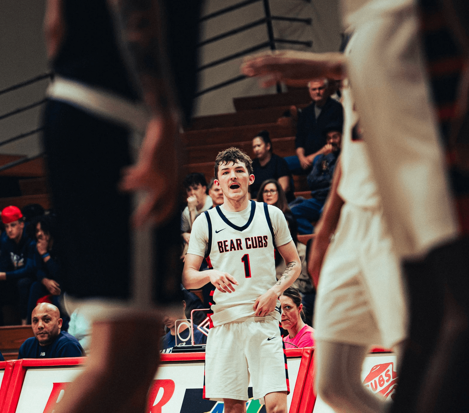 A cinematic nighttime portrait of a woman with red lipstick, captured with warm, blurred streetlights in the background.
