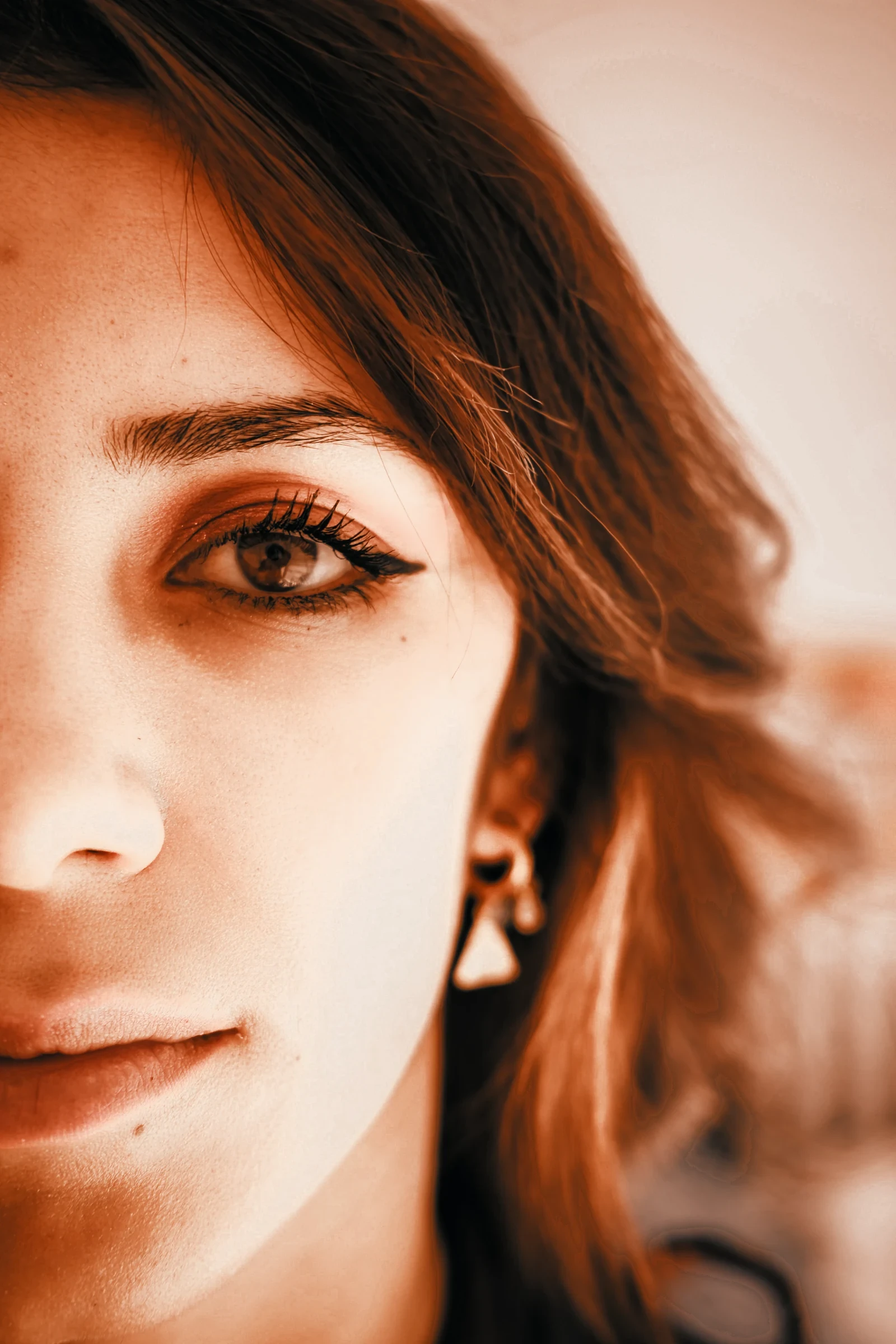 Half of a face with earrings