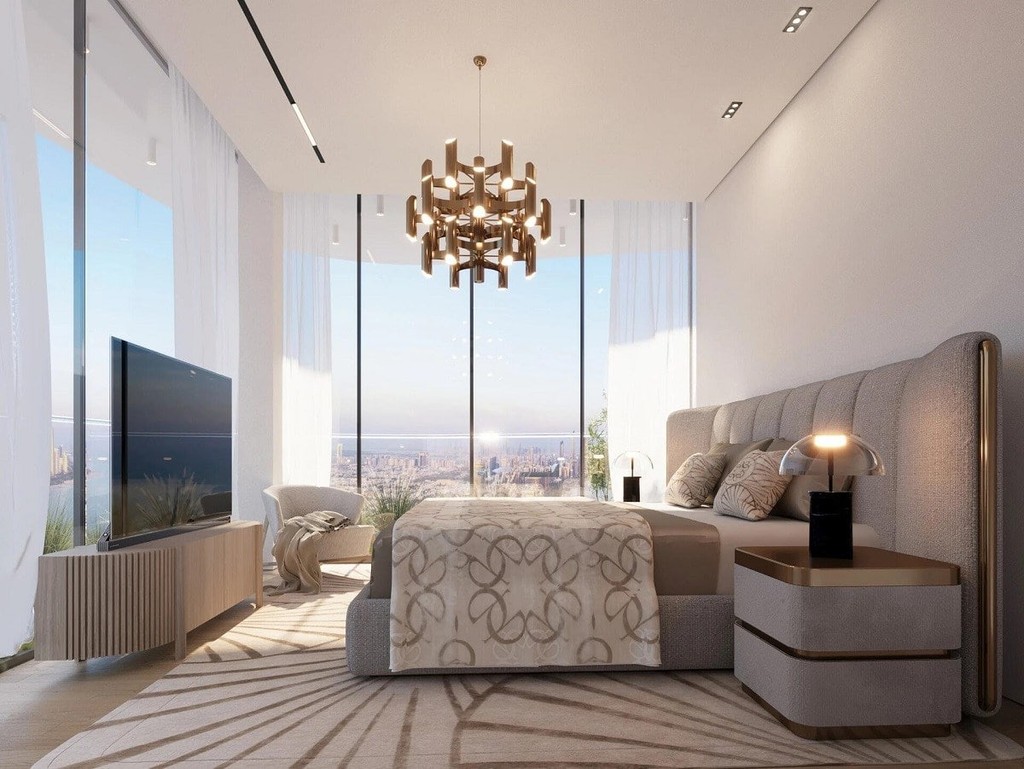 A spacious bedroom featuring a large bed and an expansive mirror, designed in an elegant style.