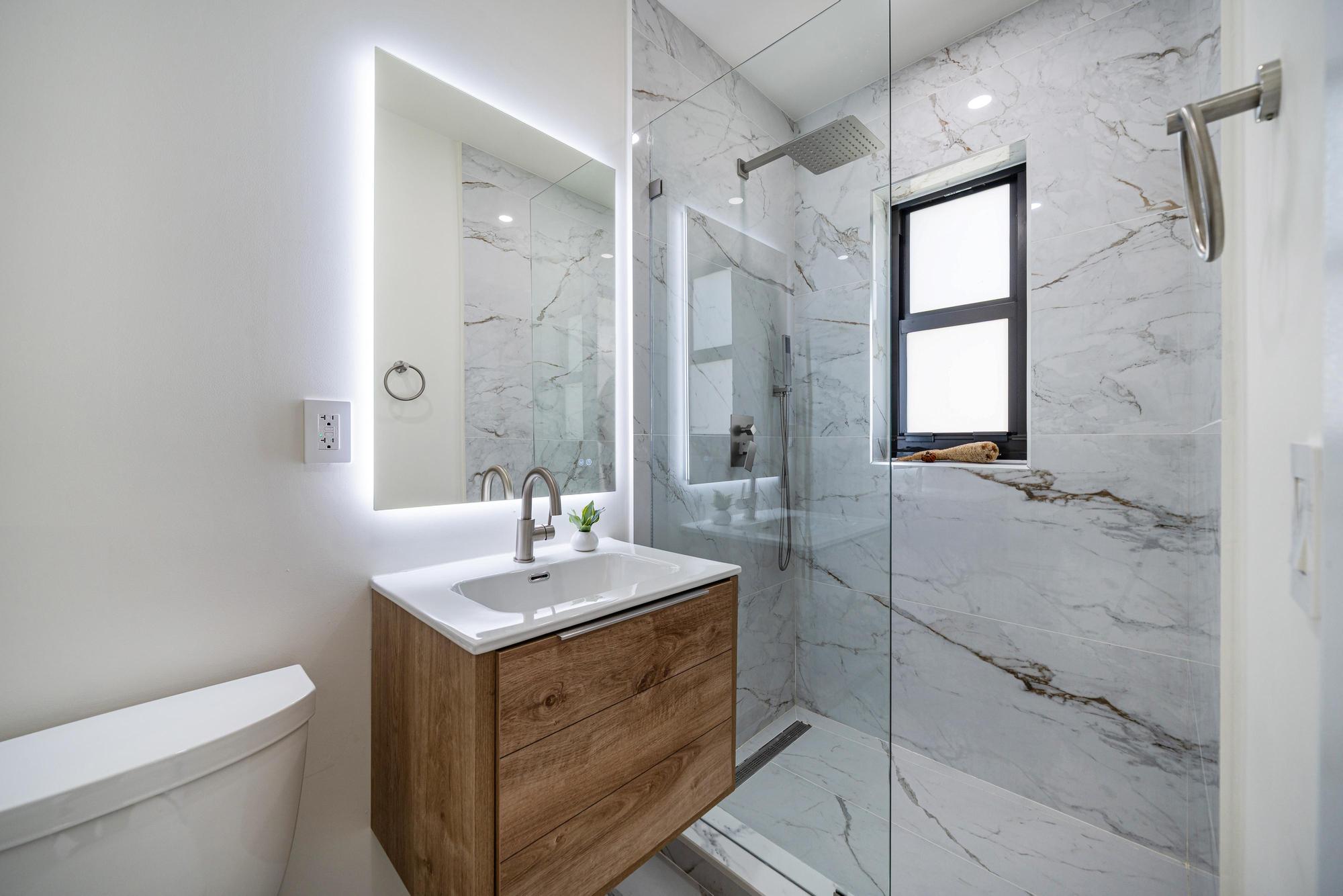 Miami Shores Residence marble bathroom with wood vanity