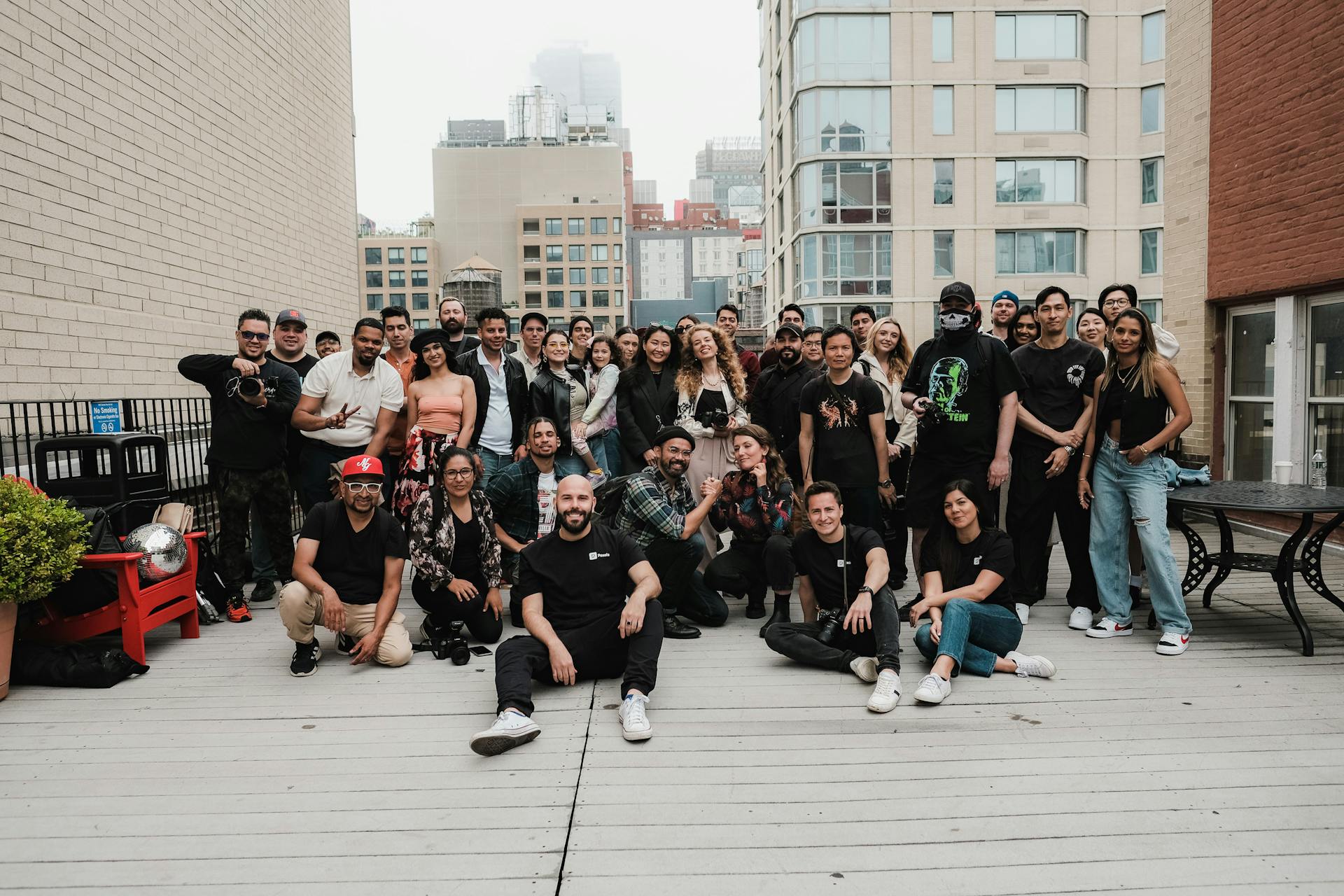 A team of people on a rooftop in a single camera shot
