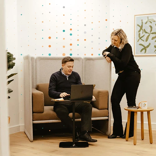 people talking looking at a laptop