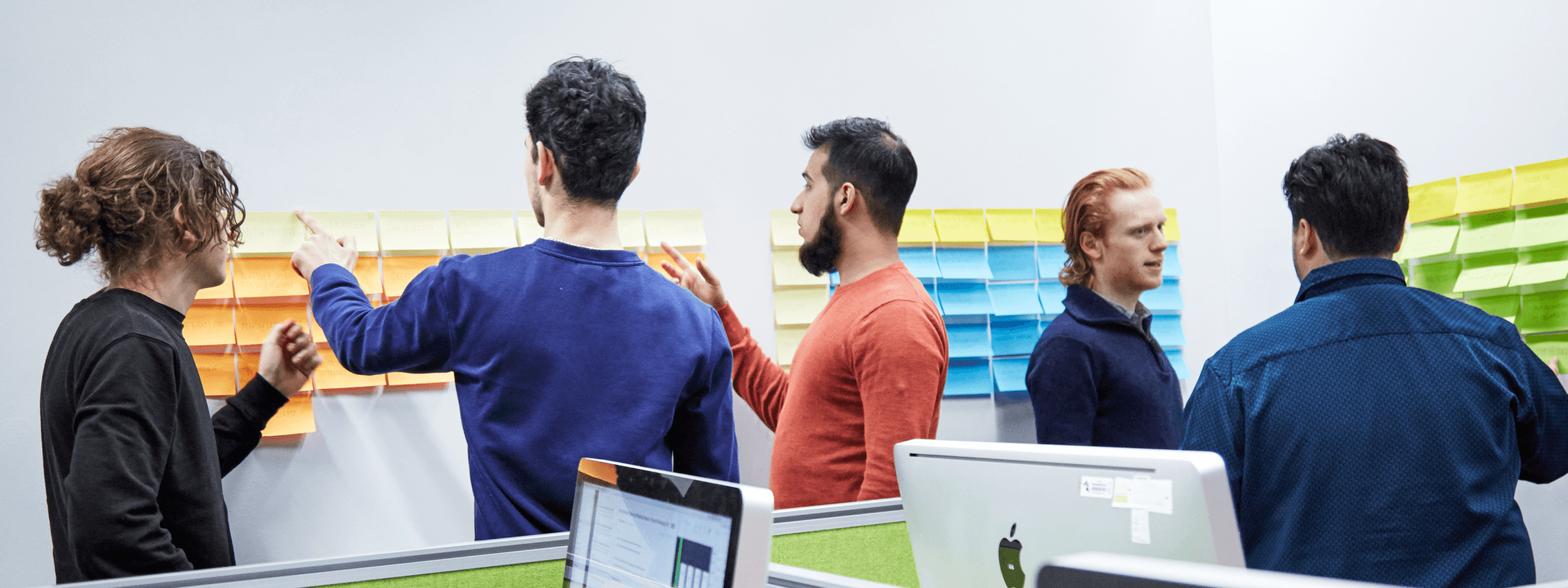 Photo of each legal requirement put on post it notes. Five people are discussing which could stay or go.